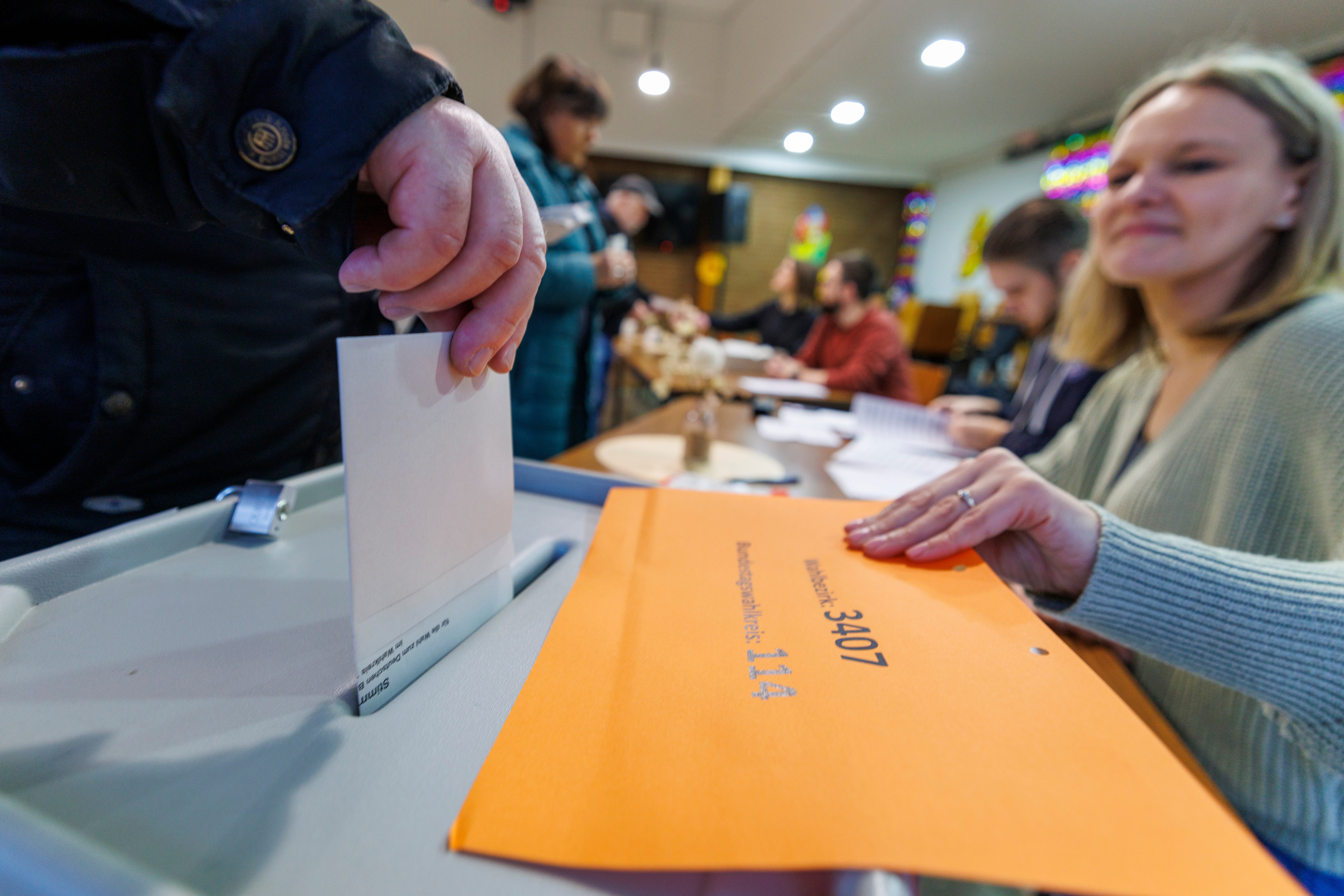 A man casts his vote at a polling station in Duisburg, Germany, as polls open