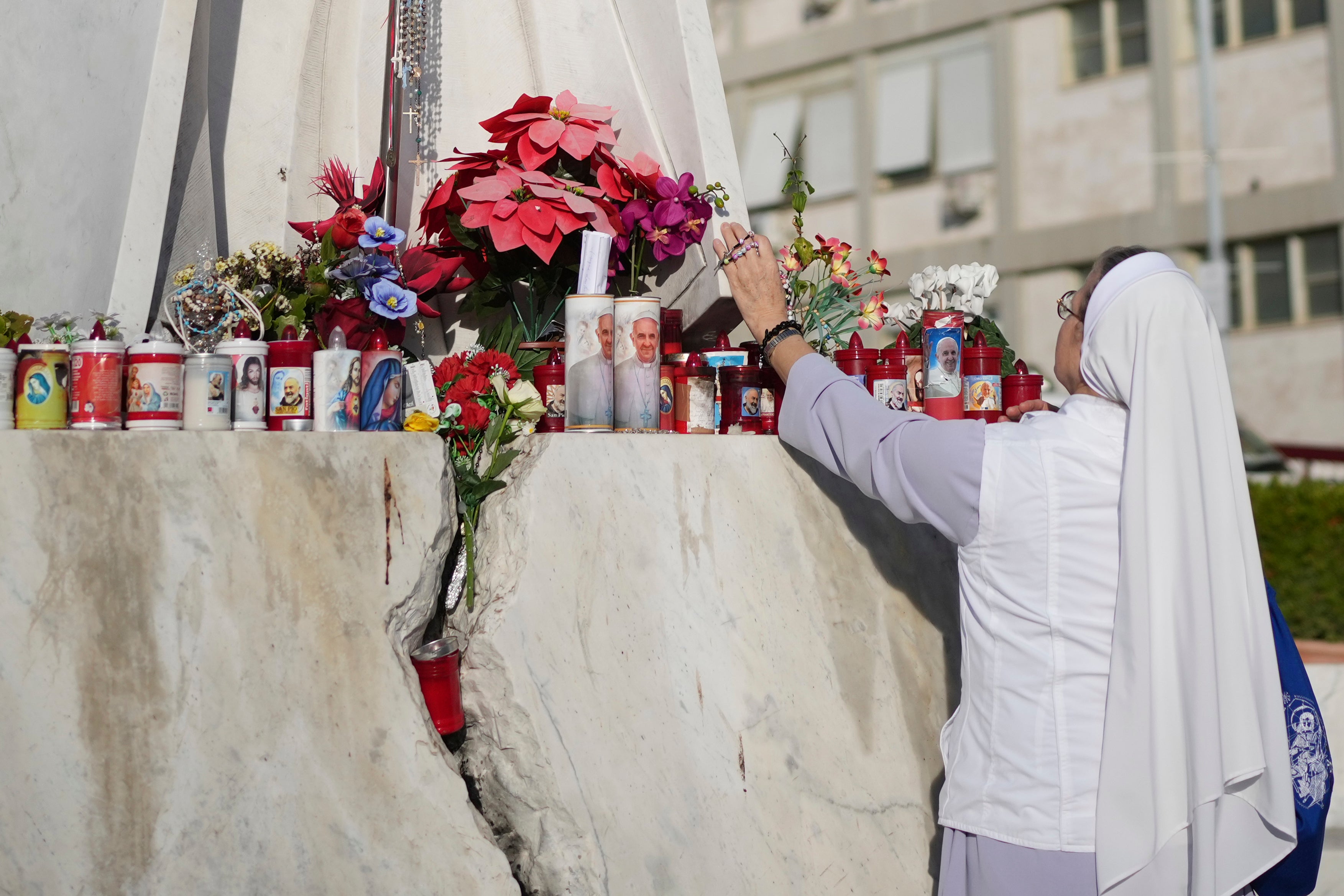 A nun prays at the Agostino Gemelli Polyclinic, in Rome, Friday, Feb. 21, 2025