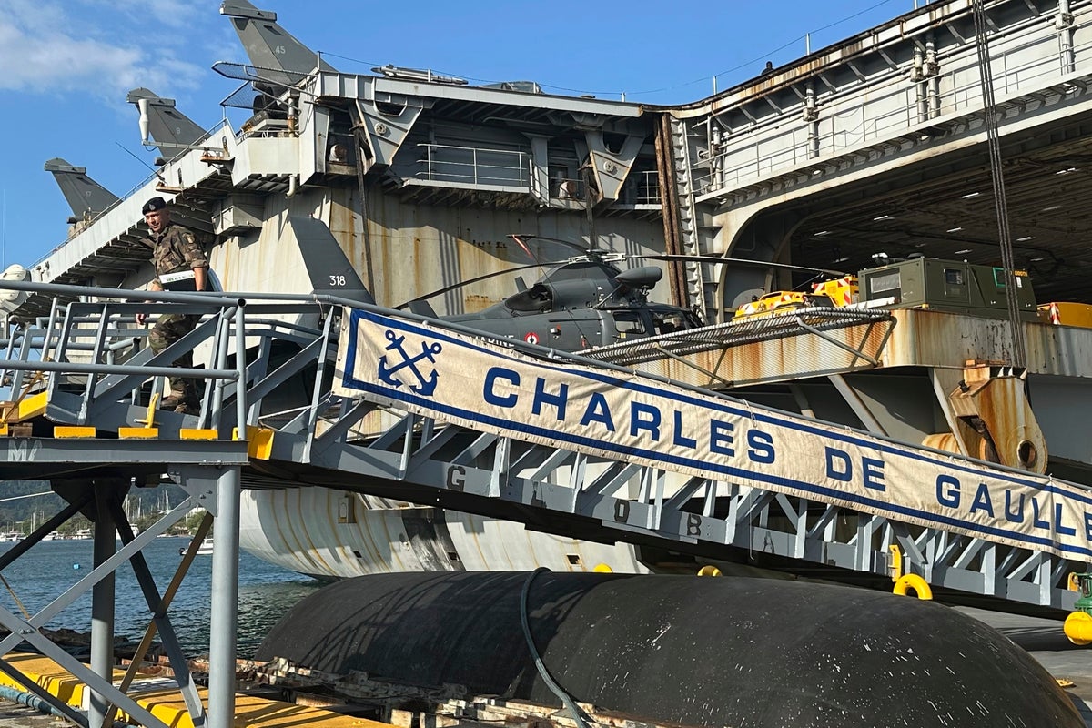 French aircraft carrier stages combat drills with Filipinos in disputed sea and visits Philippines