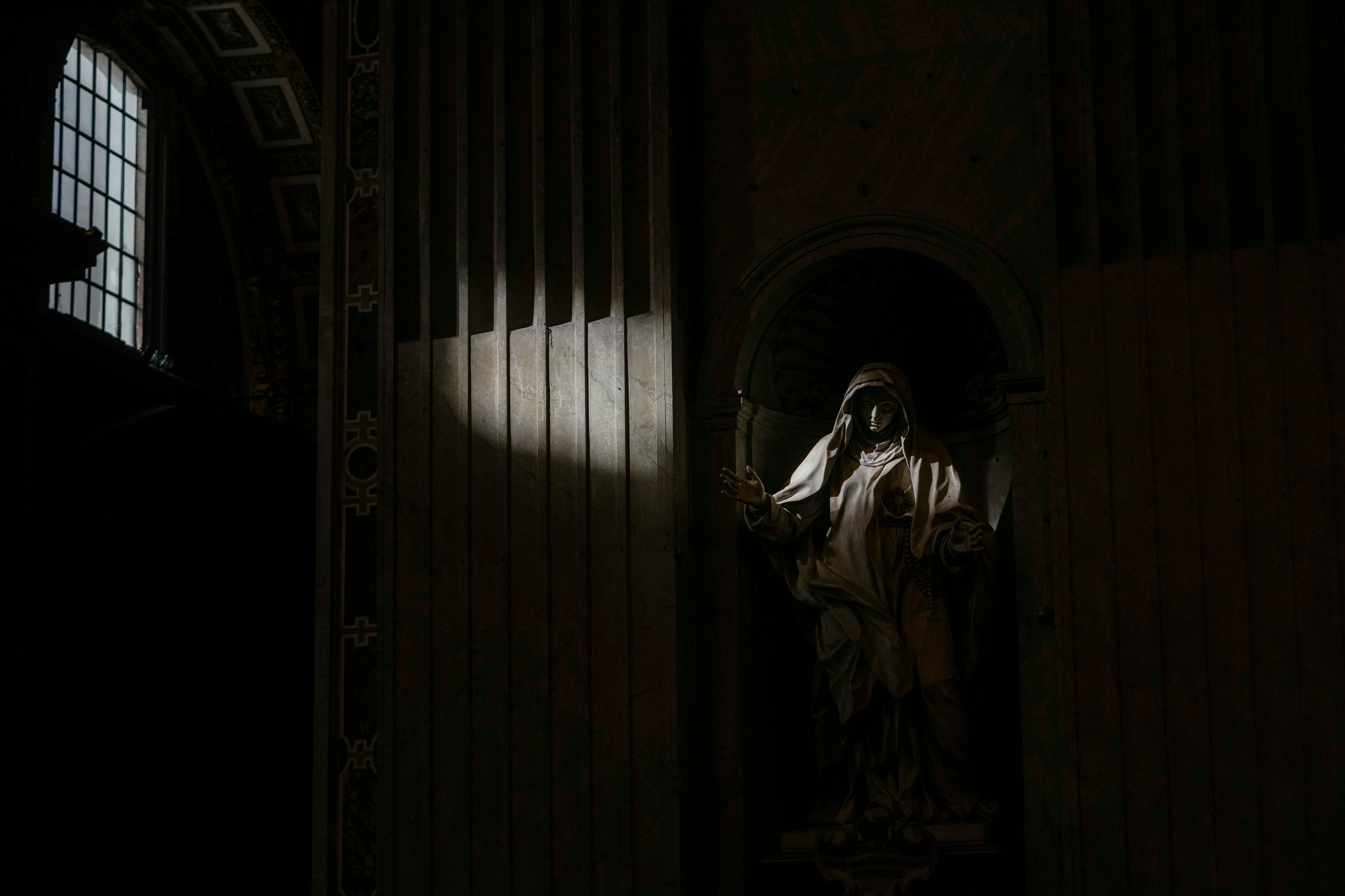 Sunlight filtering through a window illuminates the statue of Catholic Saint Giuliana Falconieri during a mass for the Jubilee of Deacons in St. Peter's Basilica at The Vatican, Sunday, Feb. 23, 202