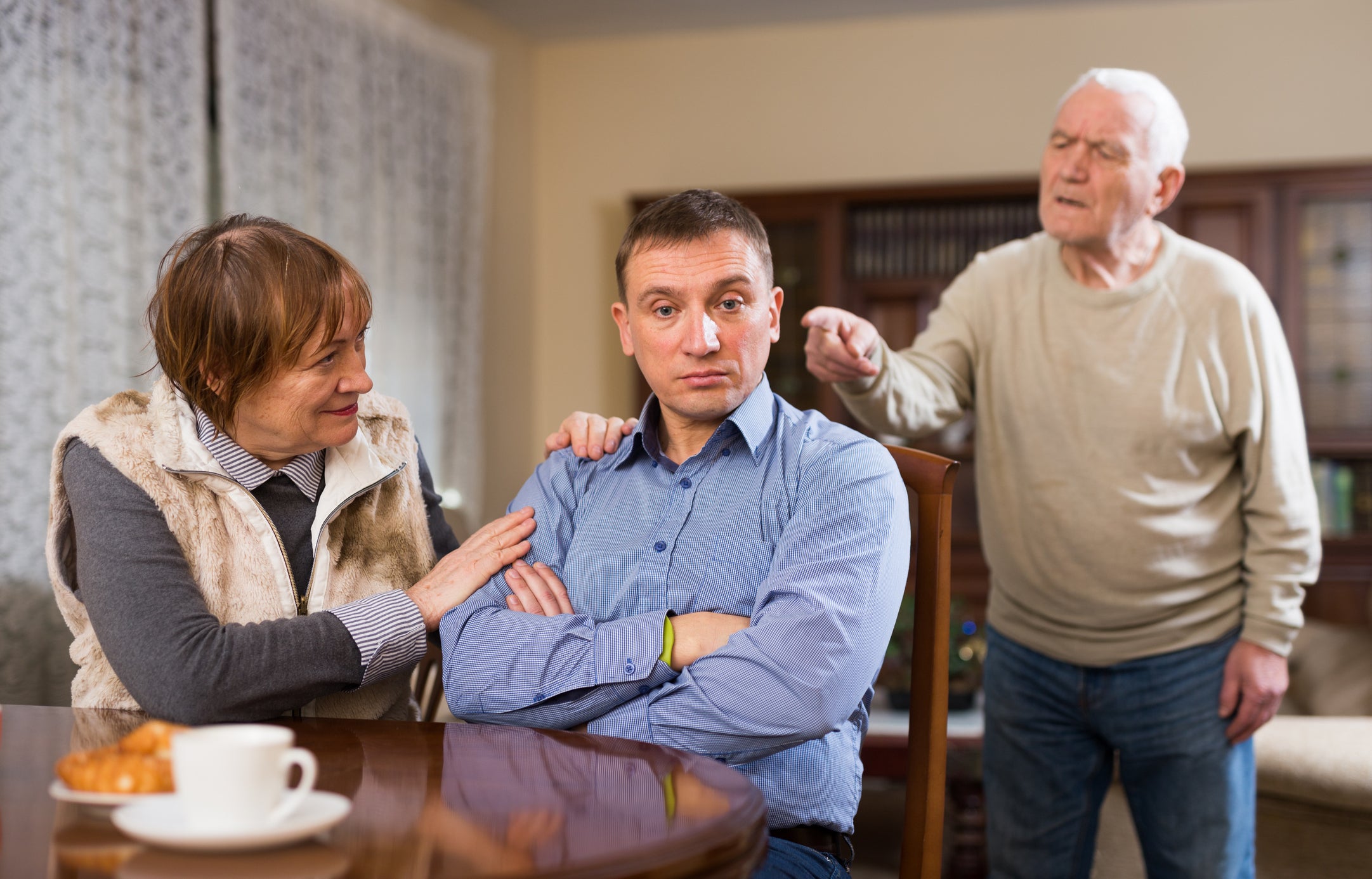 An adult son with his parents