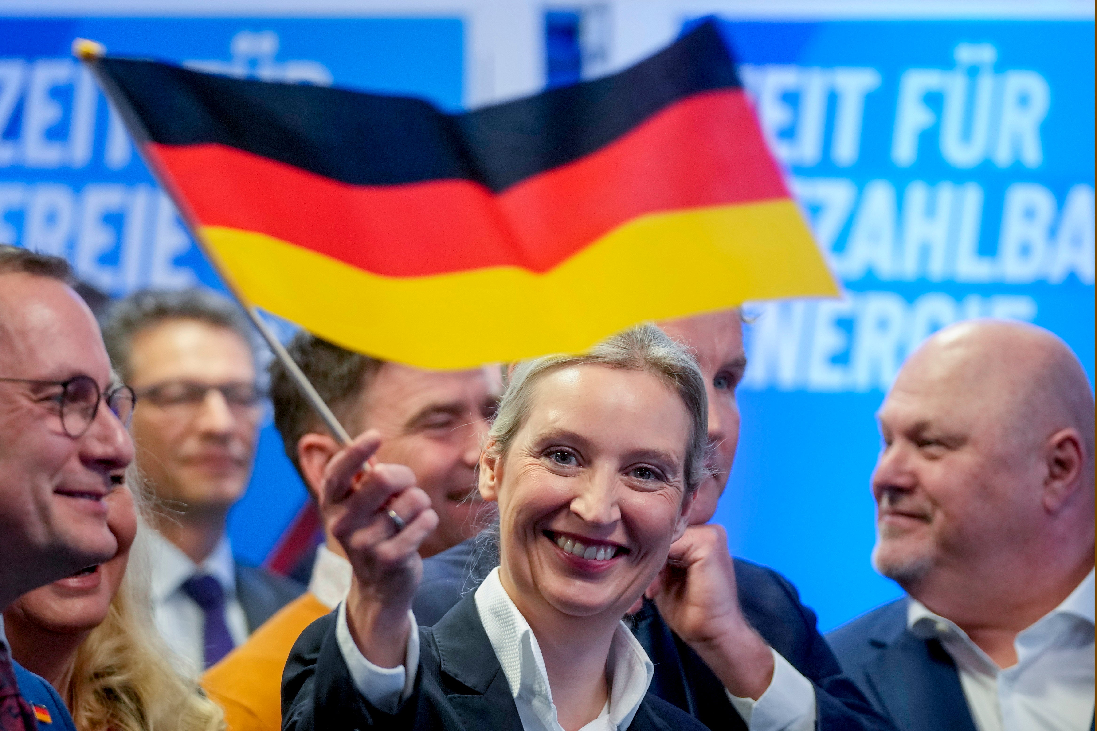 Leader of far right AfD Alice Weidel waves a German flag at her party’s headquarters in Berlin on Sunday after the German national election