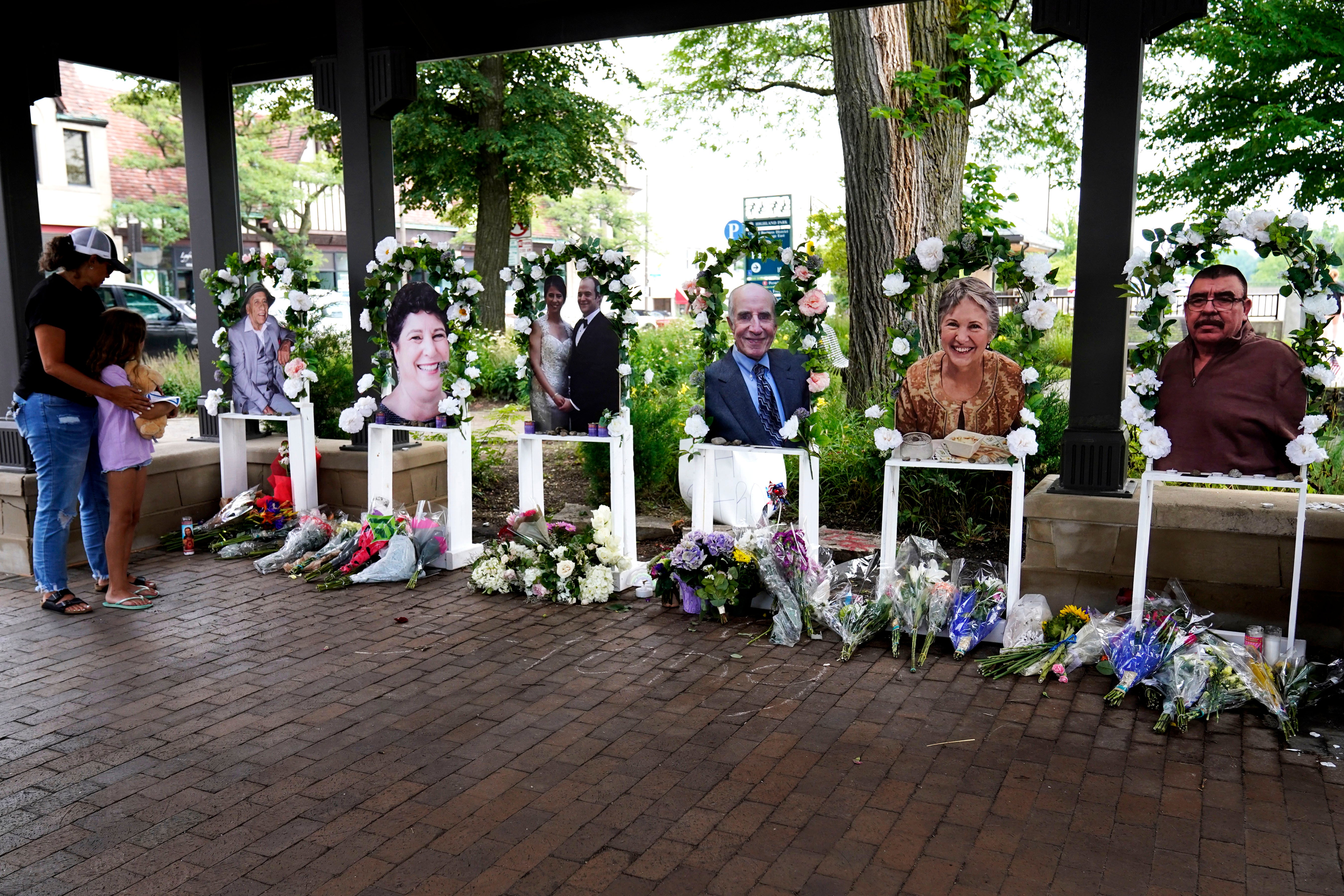 Visitors pay their respects for the seven people killed in the Fourth of July mass shooting in Highland Park