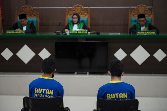 <p>Two gay men sit inside a courtroom during their trial at Sharia court in Banda Aceh, Indonesia, Monday, 24 Feb 2025</p>