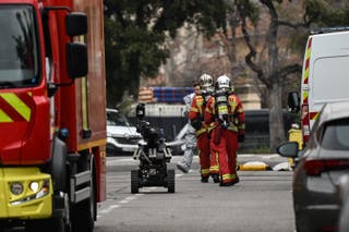 Los miembros del Batallón de Bomberos Navales de Marsella (Marins-Pompermiers de Marsella) llegan con un robot desanimado frente al consulado ruso en Marsella,