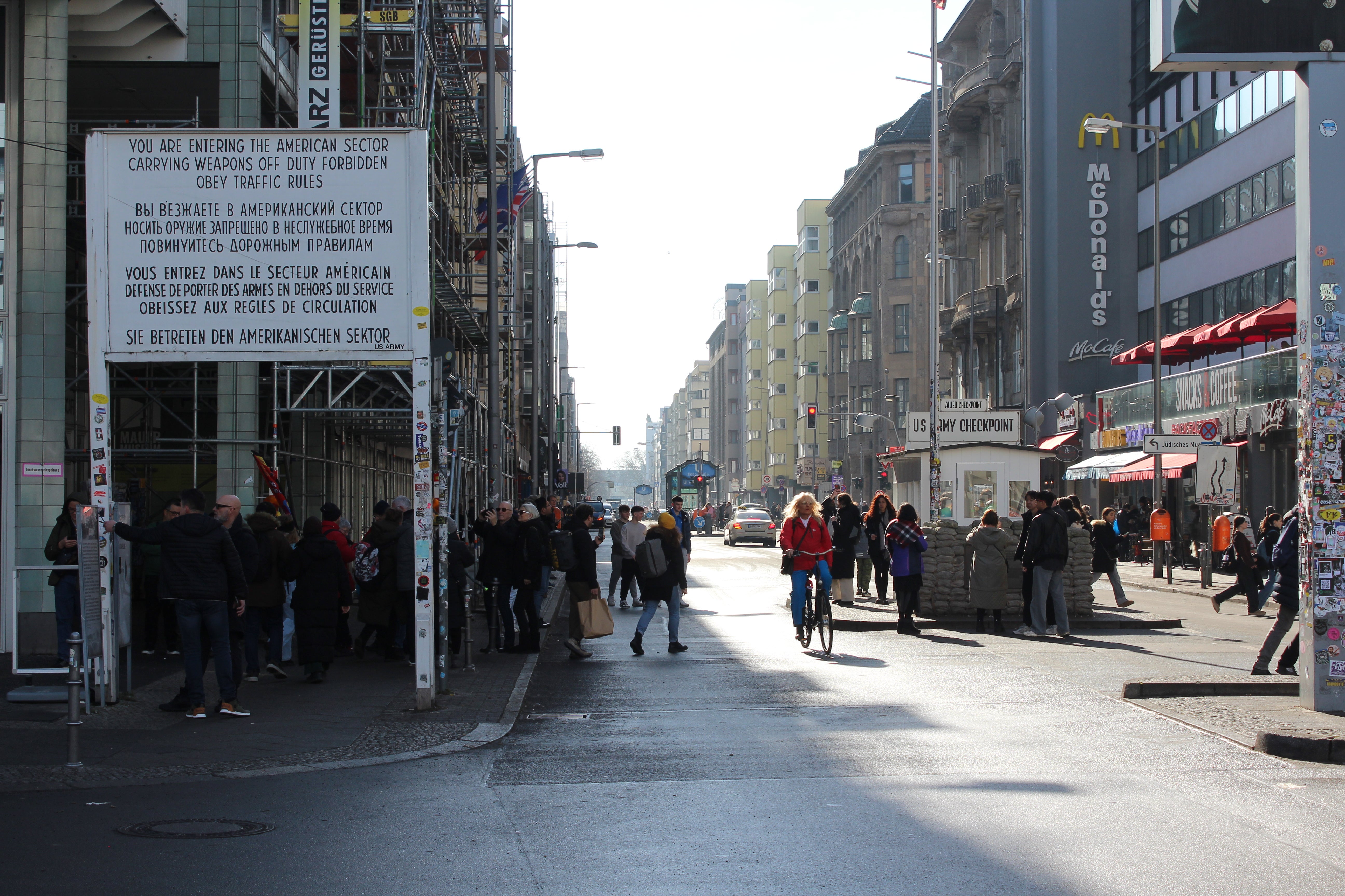 Tourists walk through Checkpoint Charlie in Berlin a day after national elections divided Germany