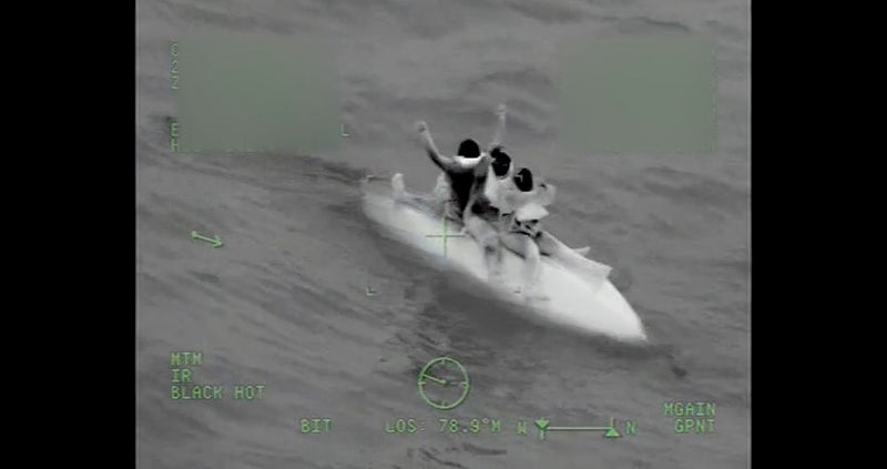 Coast Guard crews rescue three boaters stuck at sea for 9 hours after their boat capsizes