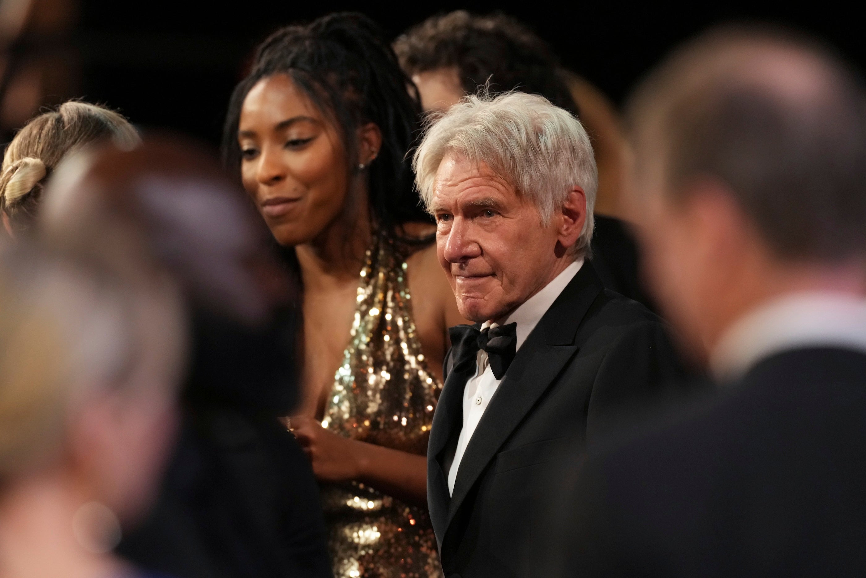 Jessica Williams, left, playfully chastized her ‘Shrinking’ co-star Harrison Ford for eating during her speech at the SAG Awards