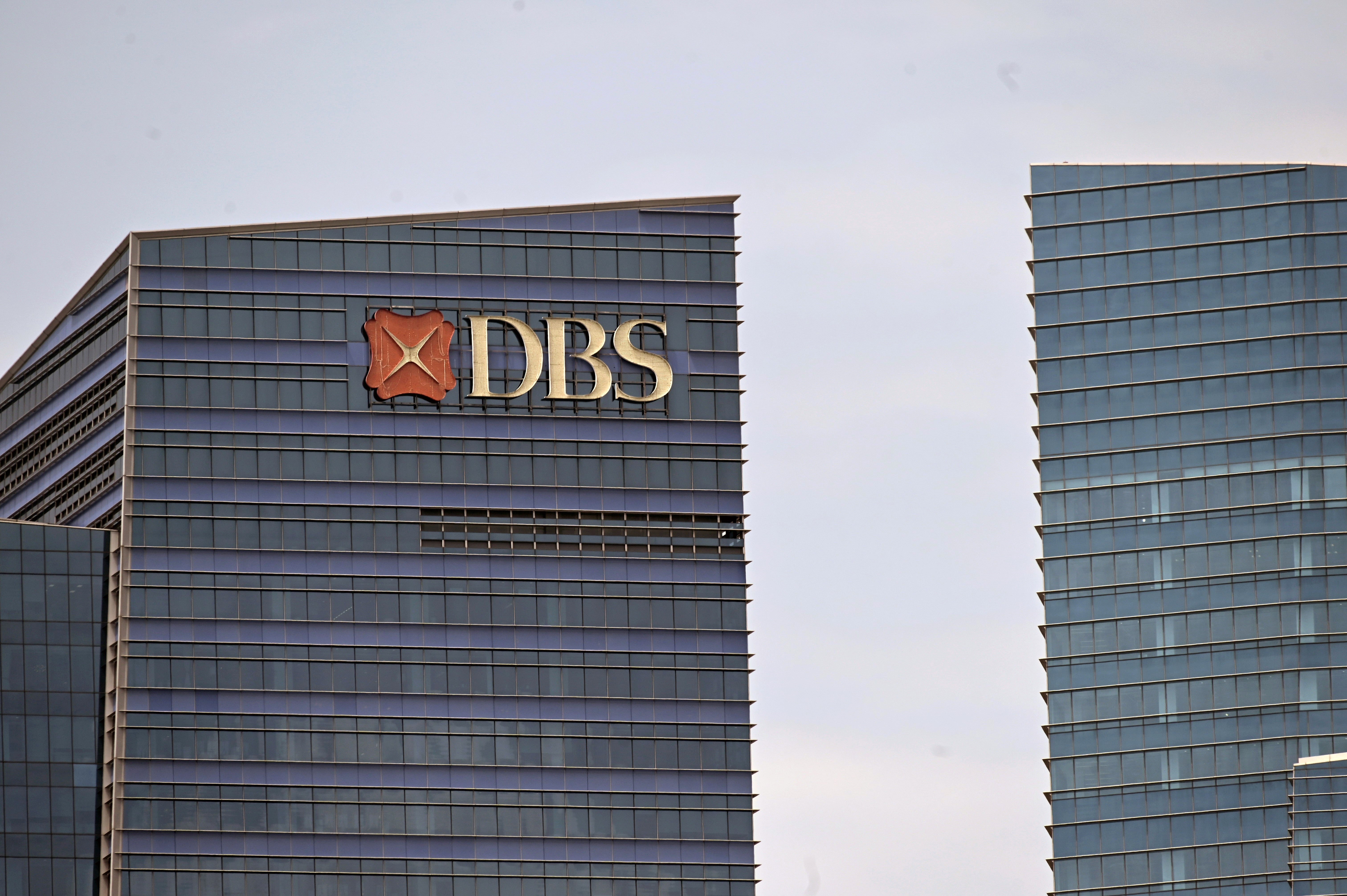 A DBS logo is displayed on a building in Singapore