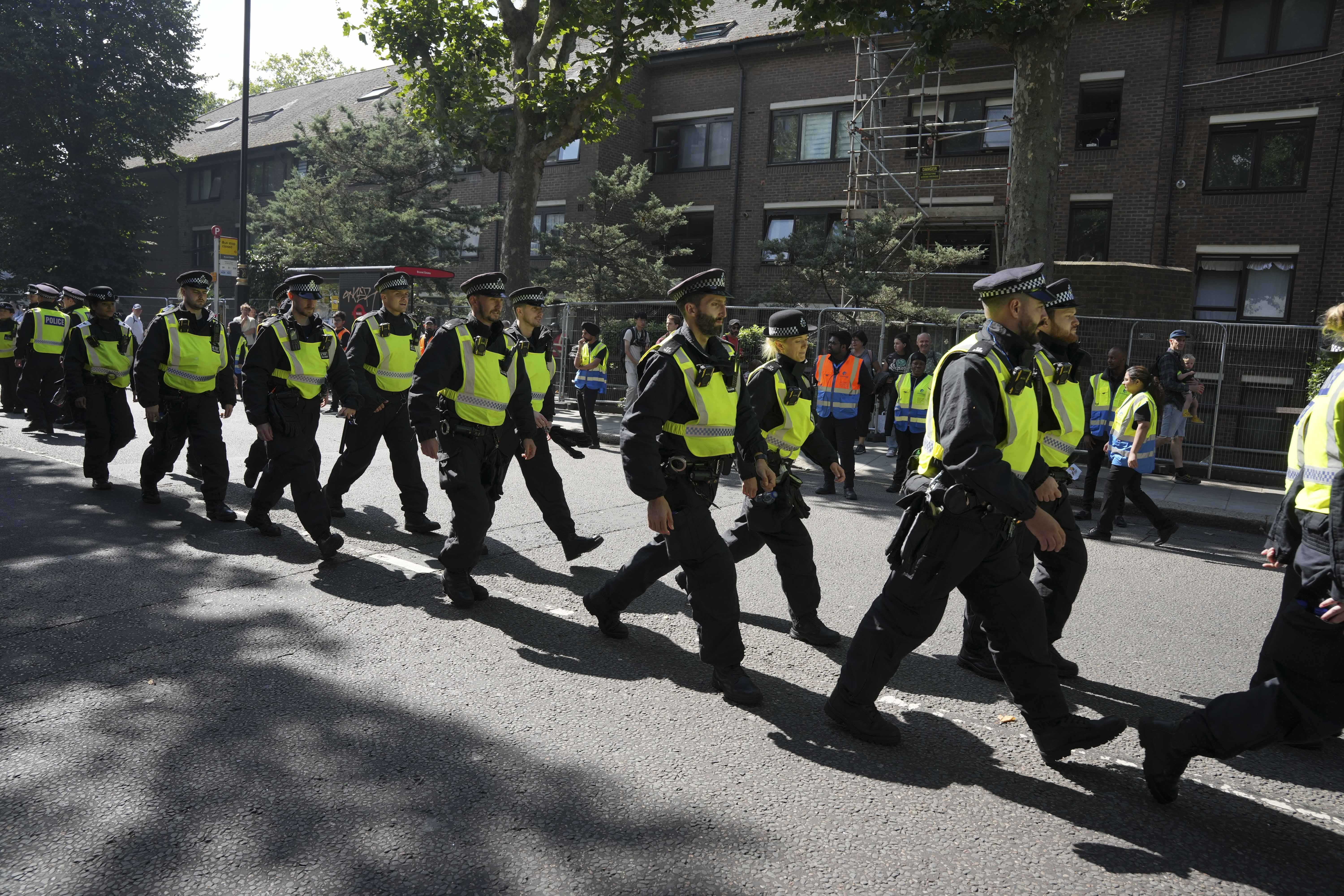 Police officers at the Children’s Day Parade, part of the Notting Hill Carnival celebration in west London on Sunday August 25 2024 (Jeff Moore/PA)