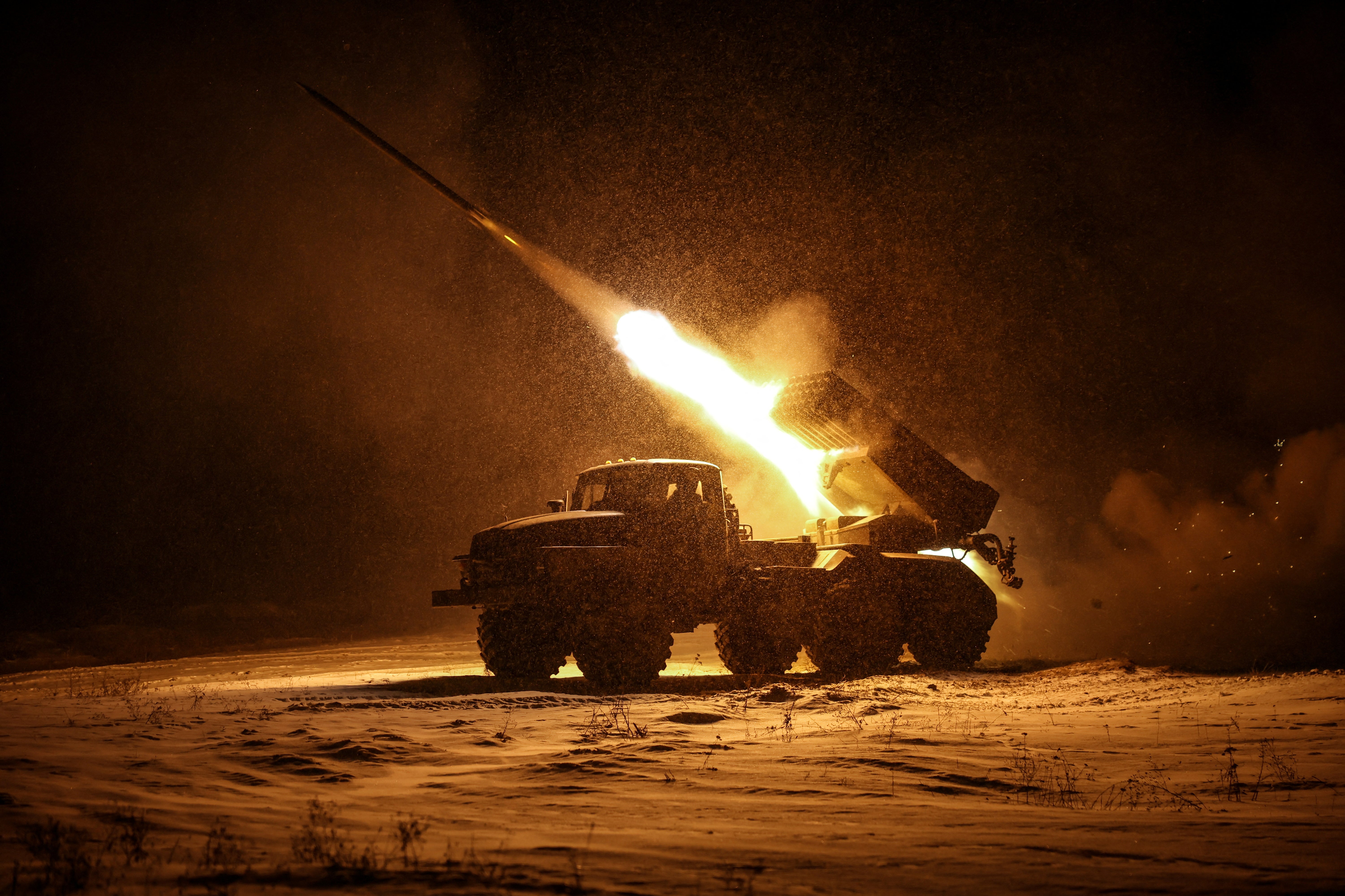 Servicemen of the 24th Mechanized Brigade of the Ukrainian Armed Forces fire a BM-21 Grad multiple-launch rocket system toward Russian troops