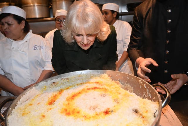 The Queen helps pack donation boxes and meets British Muslim women at a female-led restaurant ahead of Ramadan (Eddie Mulholland/DailyTelegraph/PA)
