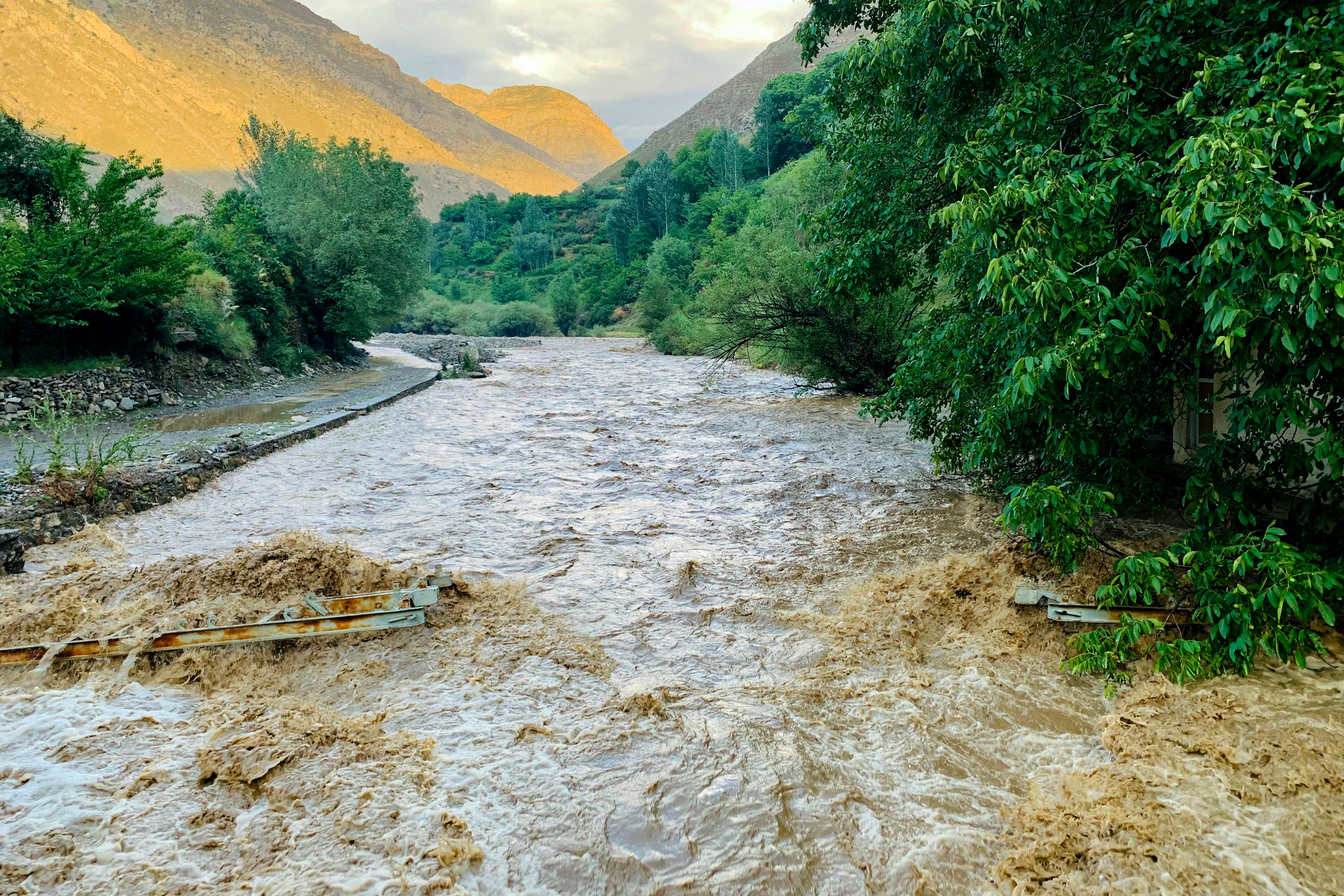 File. Flash floods gush over a damaged bridge after heavy rainfall at Qala area of Panjshir, Afghanistan, on 15 July 2024