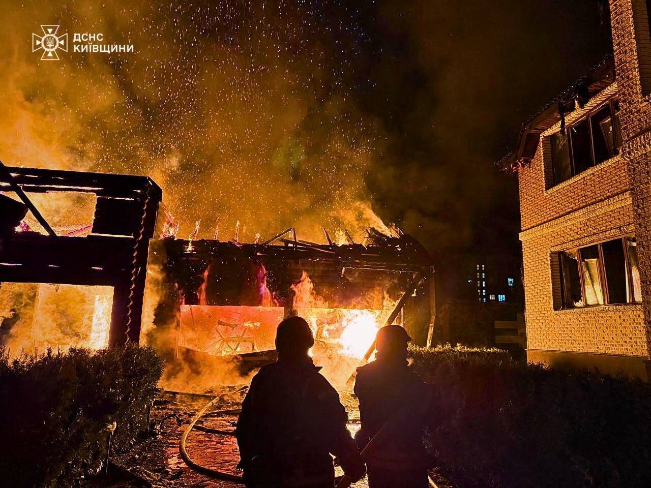 Firefighters at the scene of a Russian strike on Kyiv