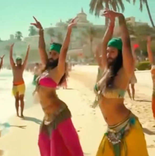 Bearded belly dancers are seen dancing on the beach in the bizarre clip (Truth Social/Donald Trump)