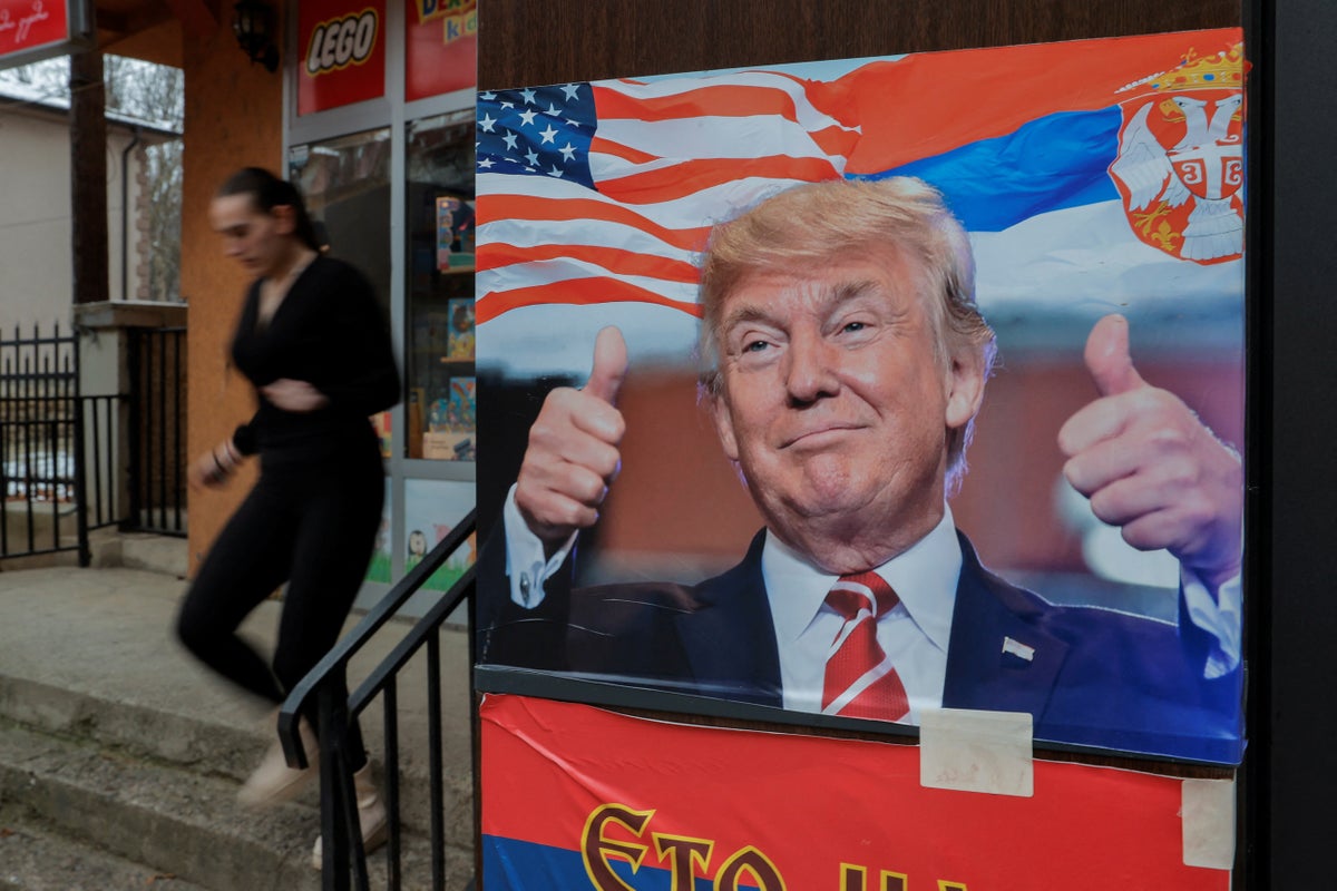 https://static.independent.co.uk/2025/02/26/9/52/A-woman-walks-near-a-poster-showing-U-S--President-Donald-Trump-with-a-Serbian-flag-in-Mitrovica-0rd.jpeg?width=1200&height=800&crop=1200:800