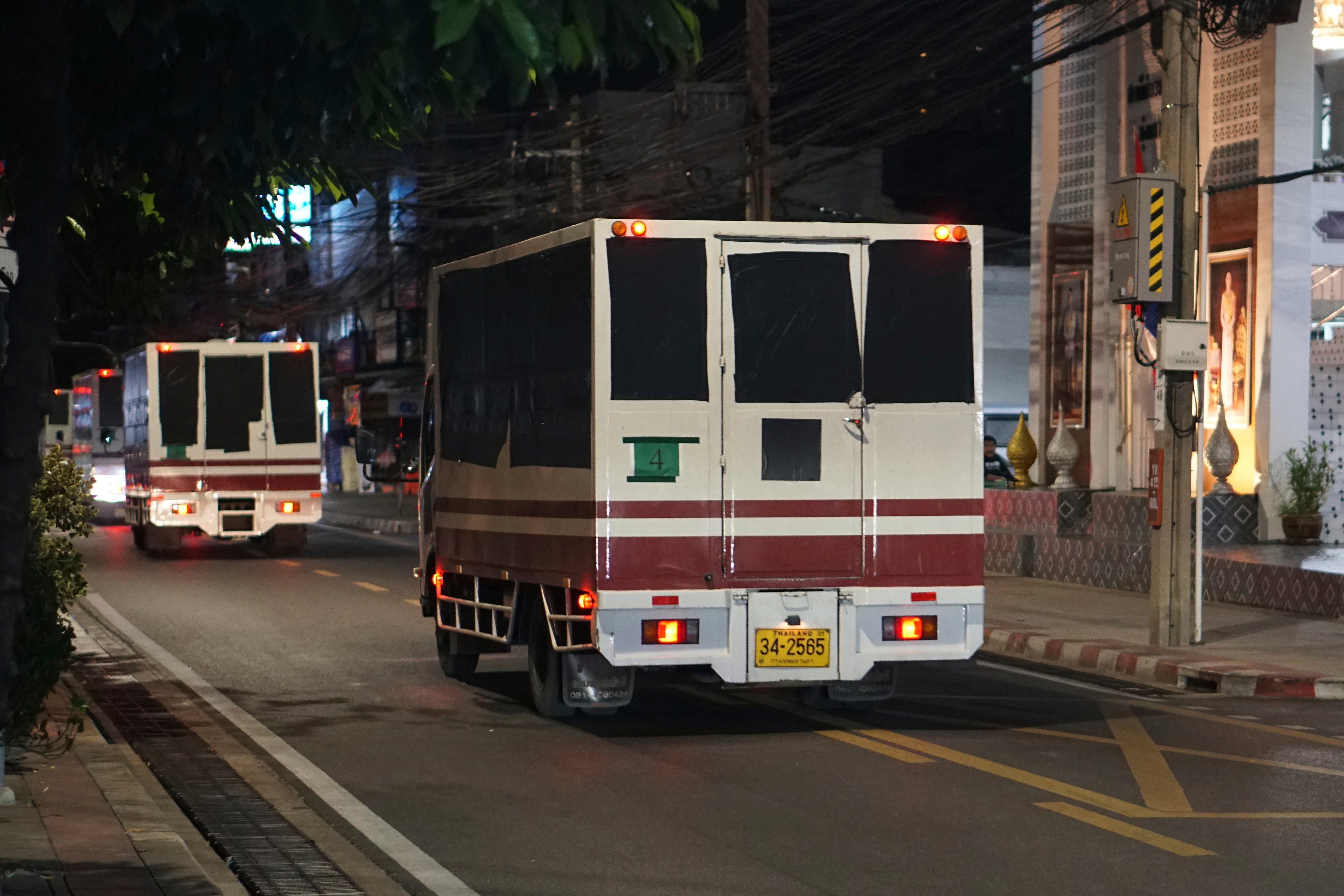 Trucks with blackened windows leave a detention center in Bangkok, Thailand