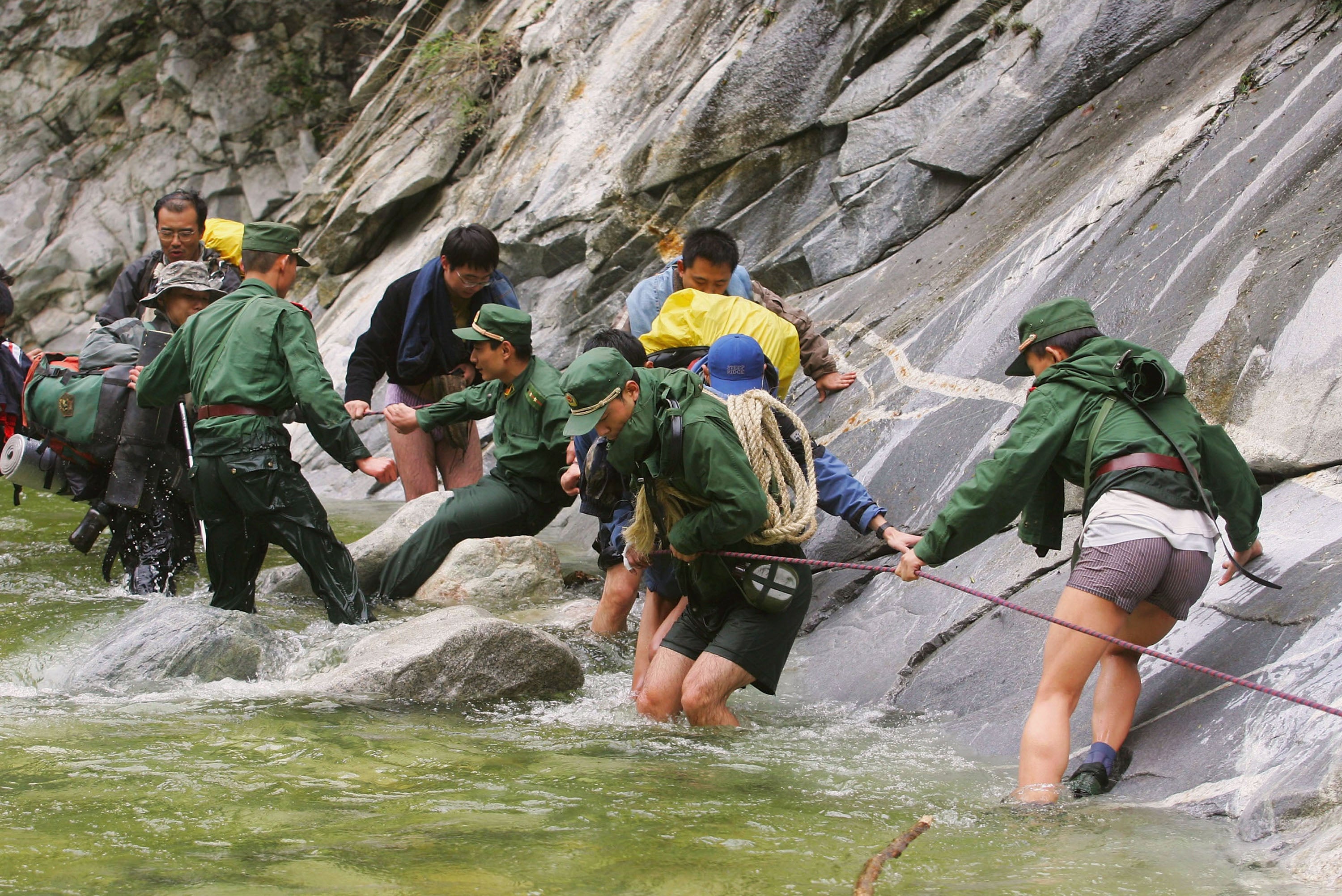 Military soldiers help mountaineers evacuate from the same Qinling mountain range during a previous rescue in 2005