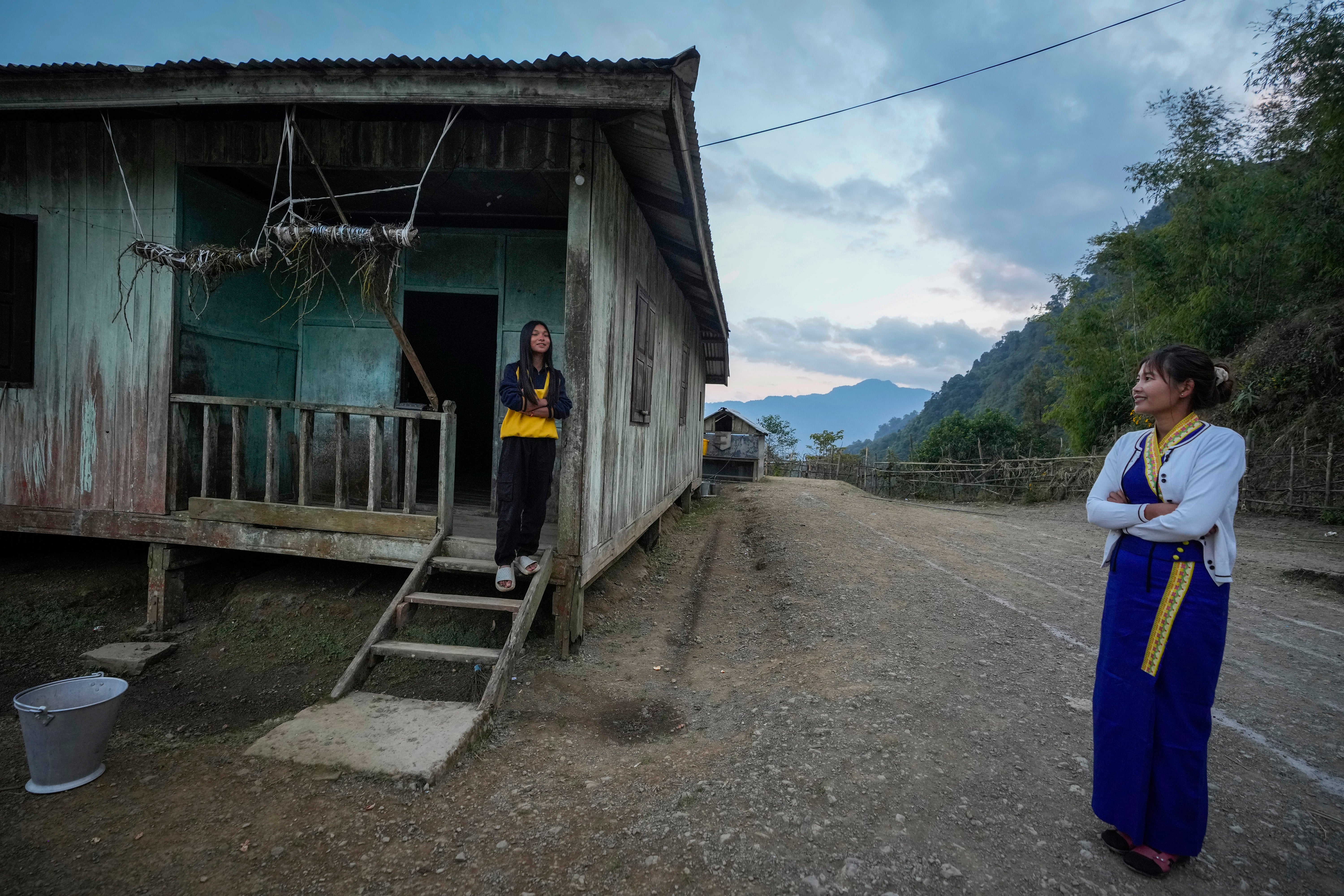 Nanhtike Thu, right, who teaches at the Myanmar government school in Longwa, speaks with her student Ngapkhao Konyak, 14