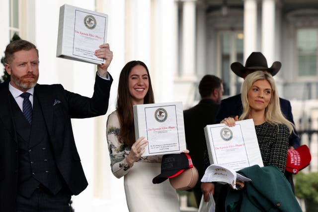 <p>People walk out of the West Wing of the White House with "The Epstein Files: Phase 1" binders, in Washington, D.C., U.S., February 27, 2025</p>