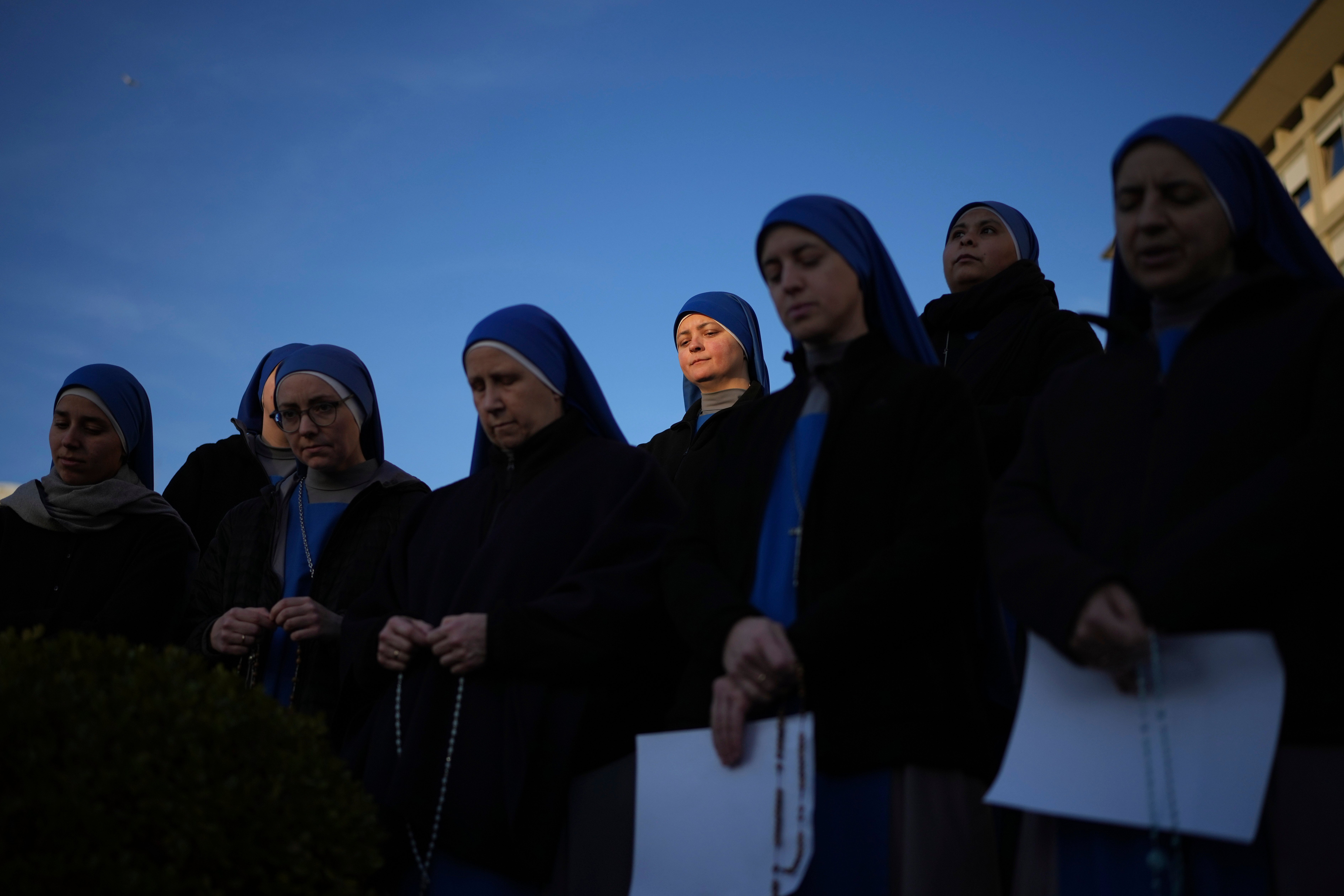 Nuns pray for Pope Francis in front of the Agostino Gemelli Polyclinic, in Rome