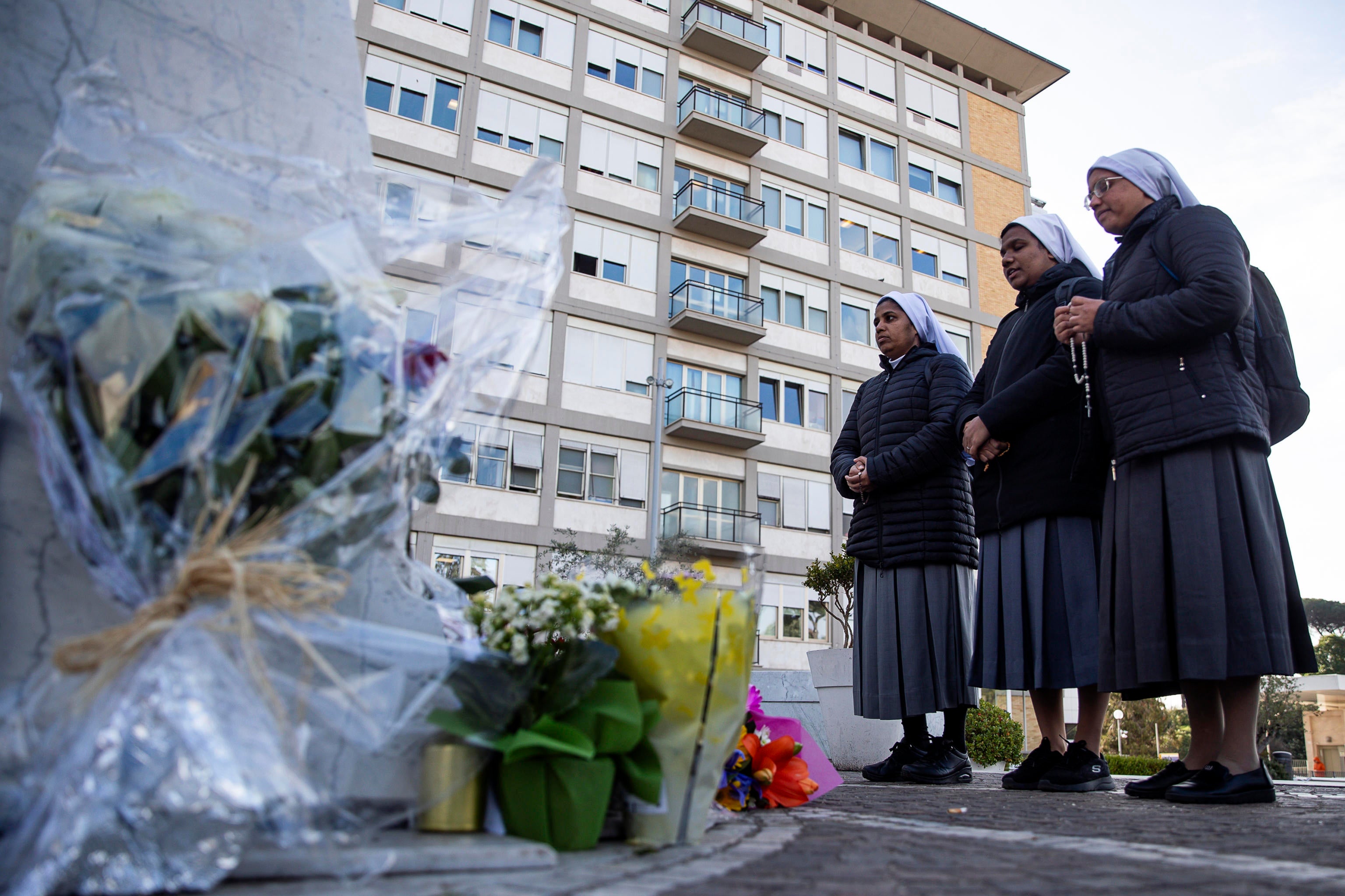 Nuns pray outside the Gemelli hospital