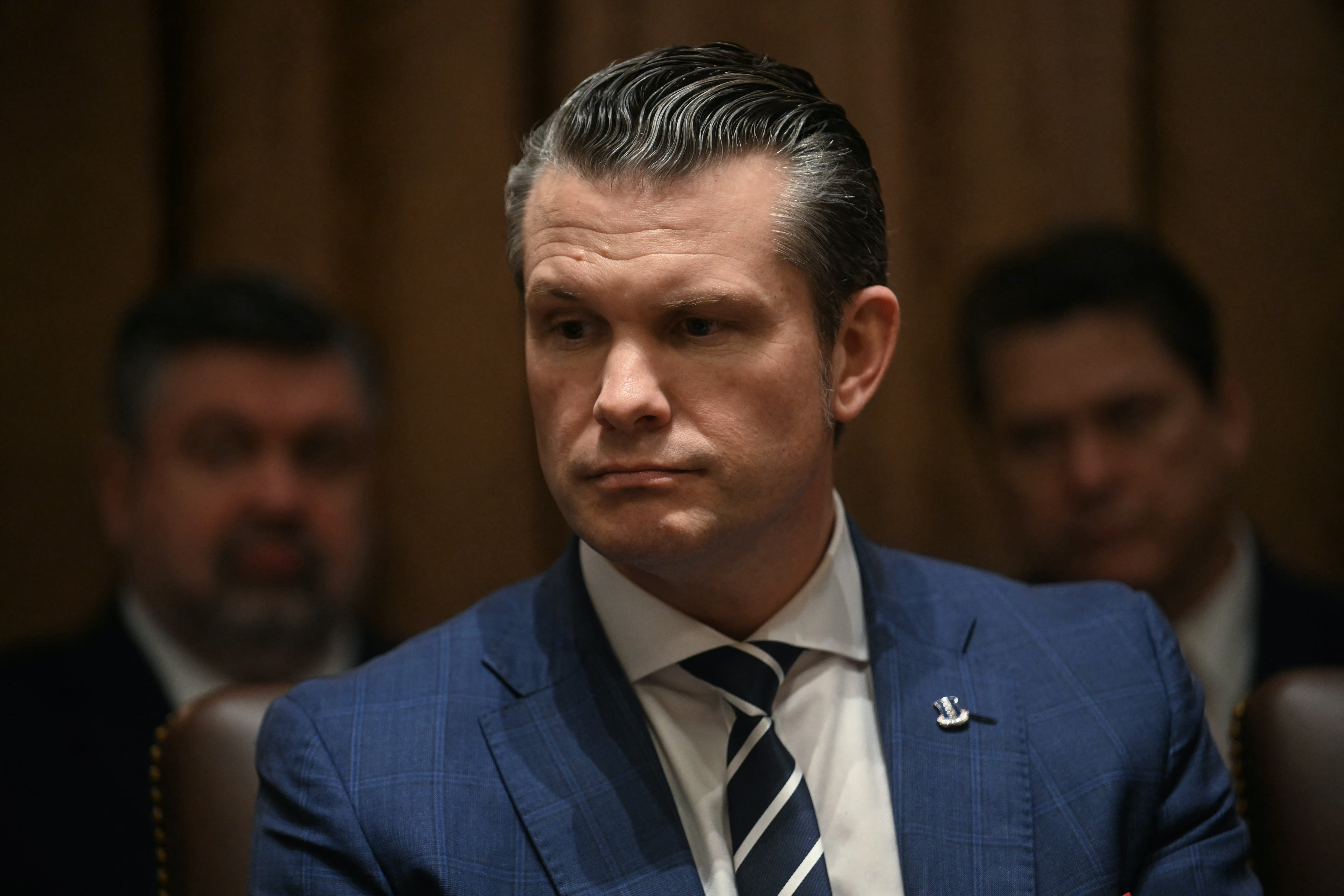 <p>US Secretary of Defense Pete Hegseth looks on as US President Donald Trump holds a cabinet meeting at the White House in Washington, DC, on February 26, 2025</p>