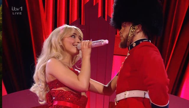 <p>Sabrina Carpenter performed raunchy moves with back-up dancers dressed as the King’s Guard</p>
