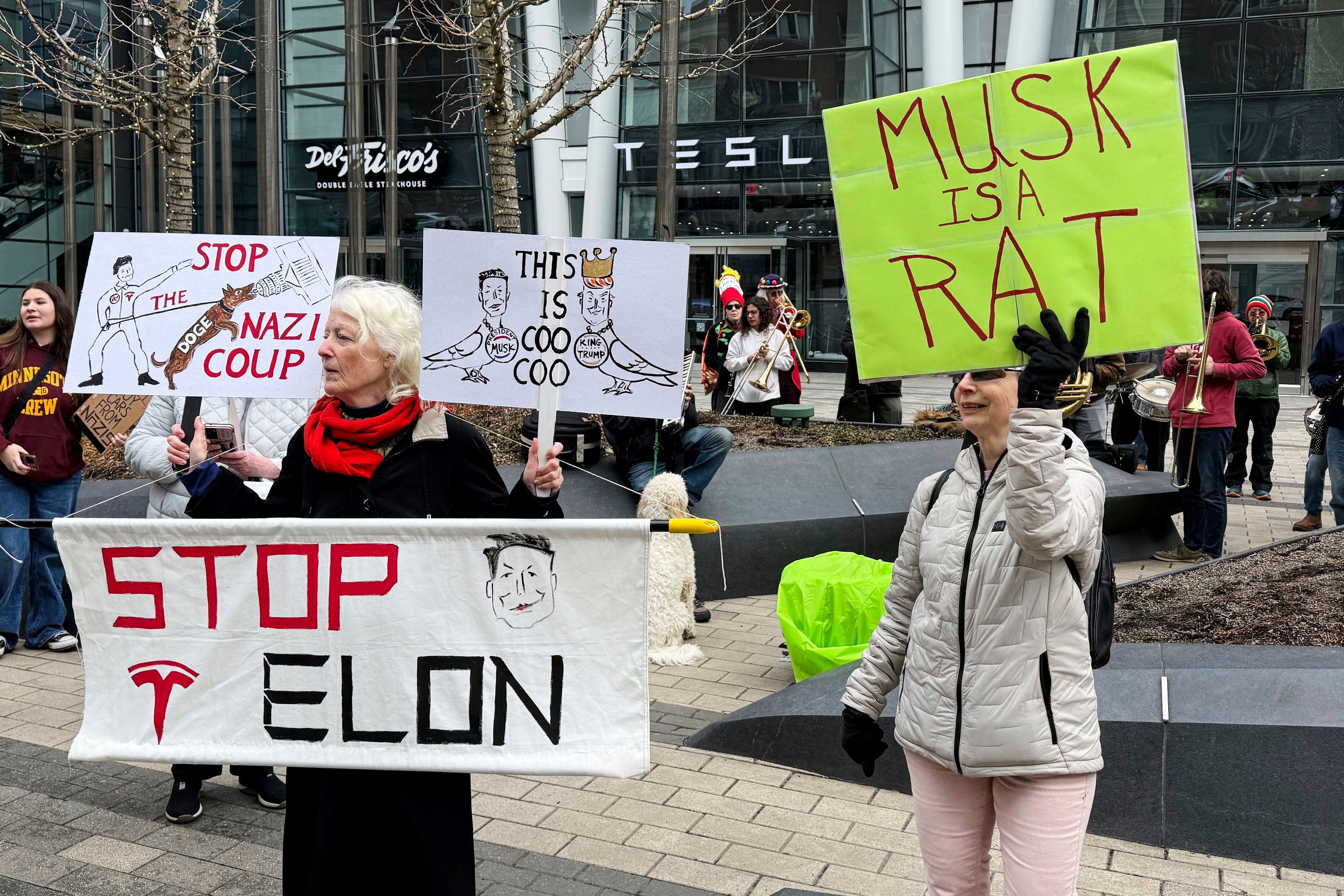 Protesters outside a Boston Tesla dealership