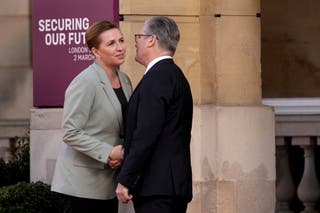 Britain's Prime Minister Keir Starmer, right, greets Denmark's Prime Minister Mette Frederiksen as she arrives for a summit on Ukraine at Lancaster House