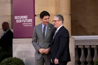 Britain's Prime Minister Keir Starmer, right, greets Canada's Prime Minister Justin Trudeau as he arrives for a summit on Ukraine at Lancaster House in London