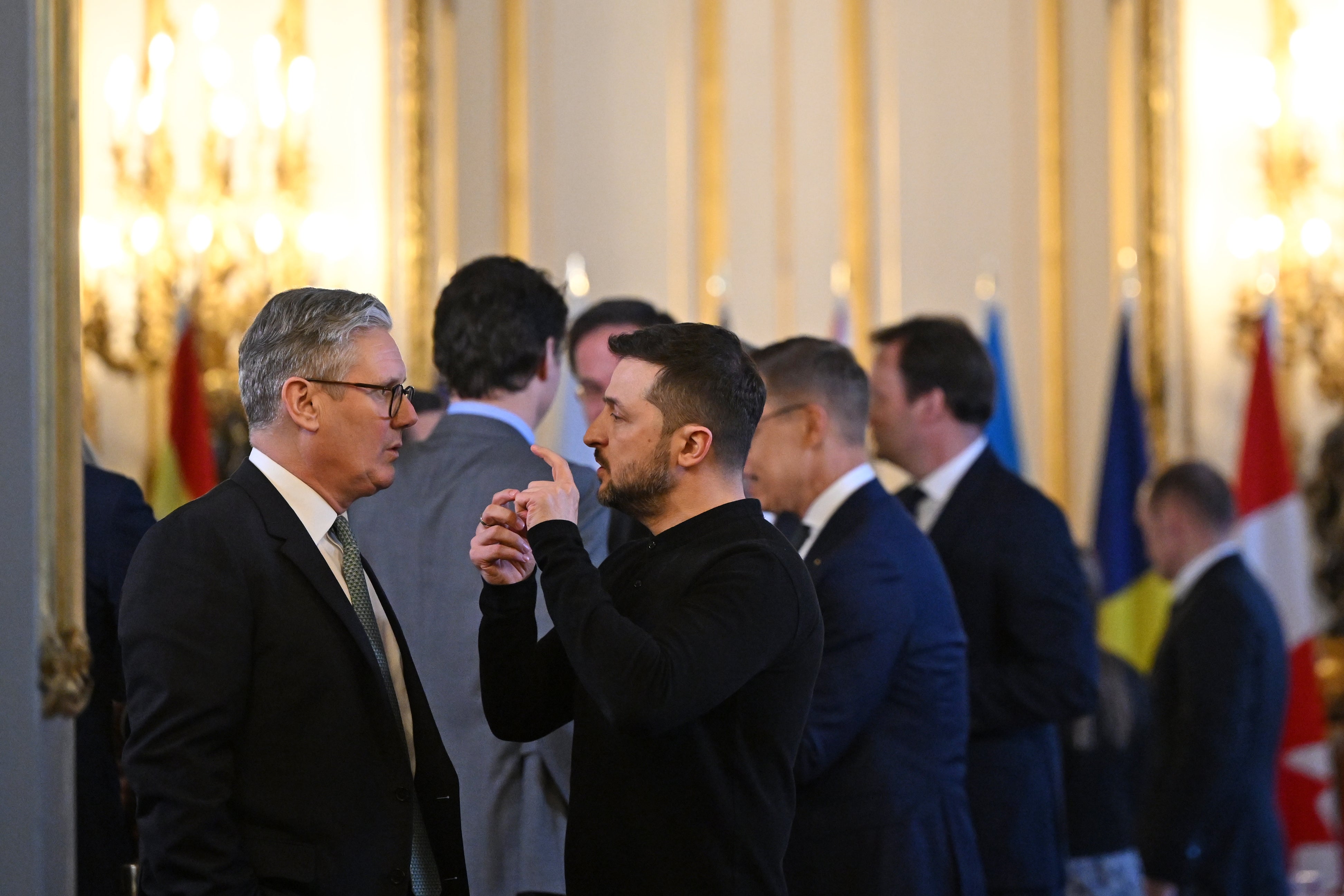 Volodymyr Zelensky and Keir Starmer chat before heading to a private room to hold a meeting during the summit