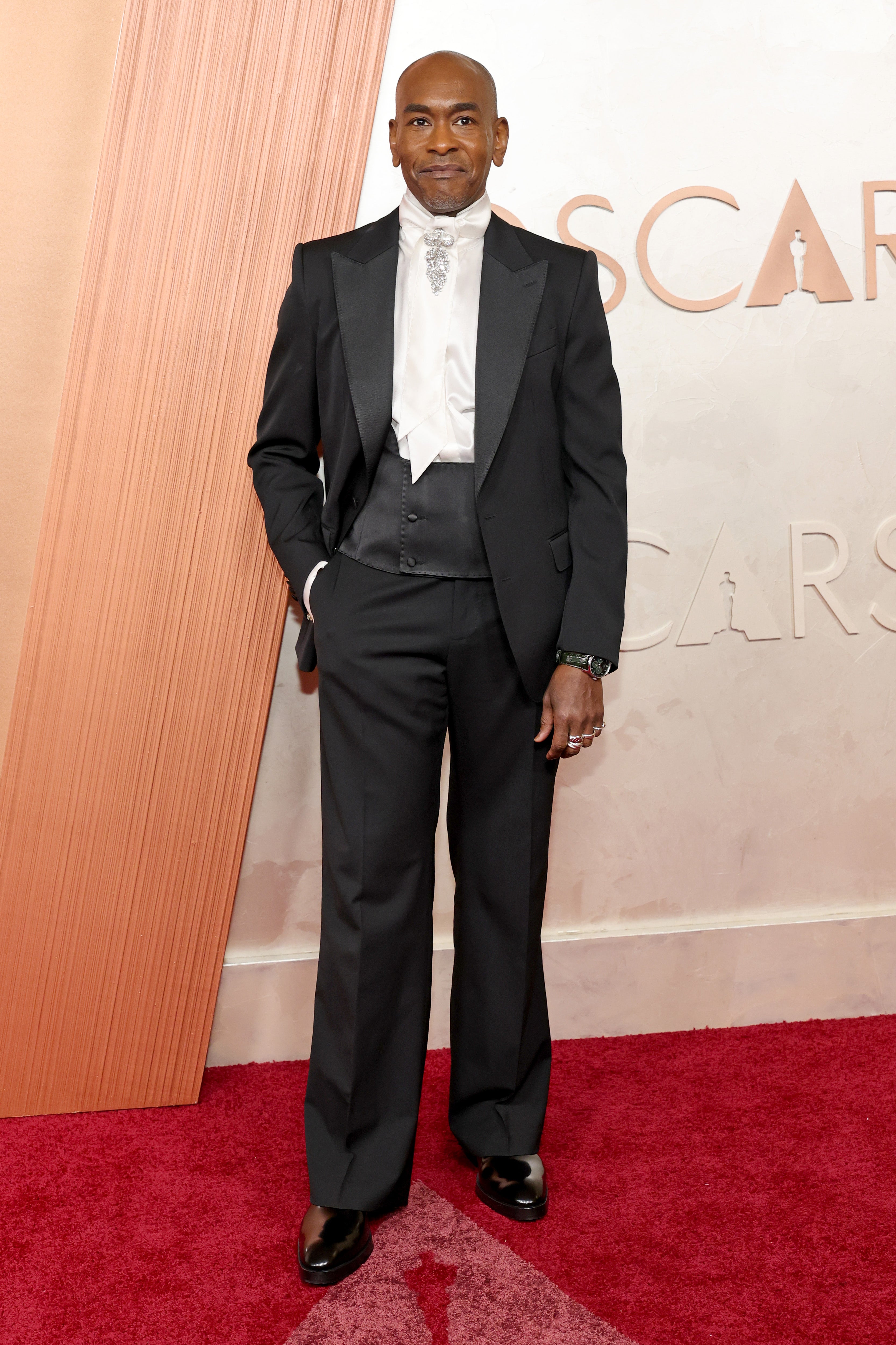 Paul Tazewell arrived to the star-studded awards ceremony in a double-breasted black tuxedo with a white satin neck tie and a jeweled embellishment