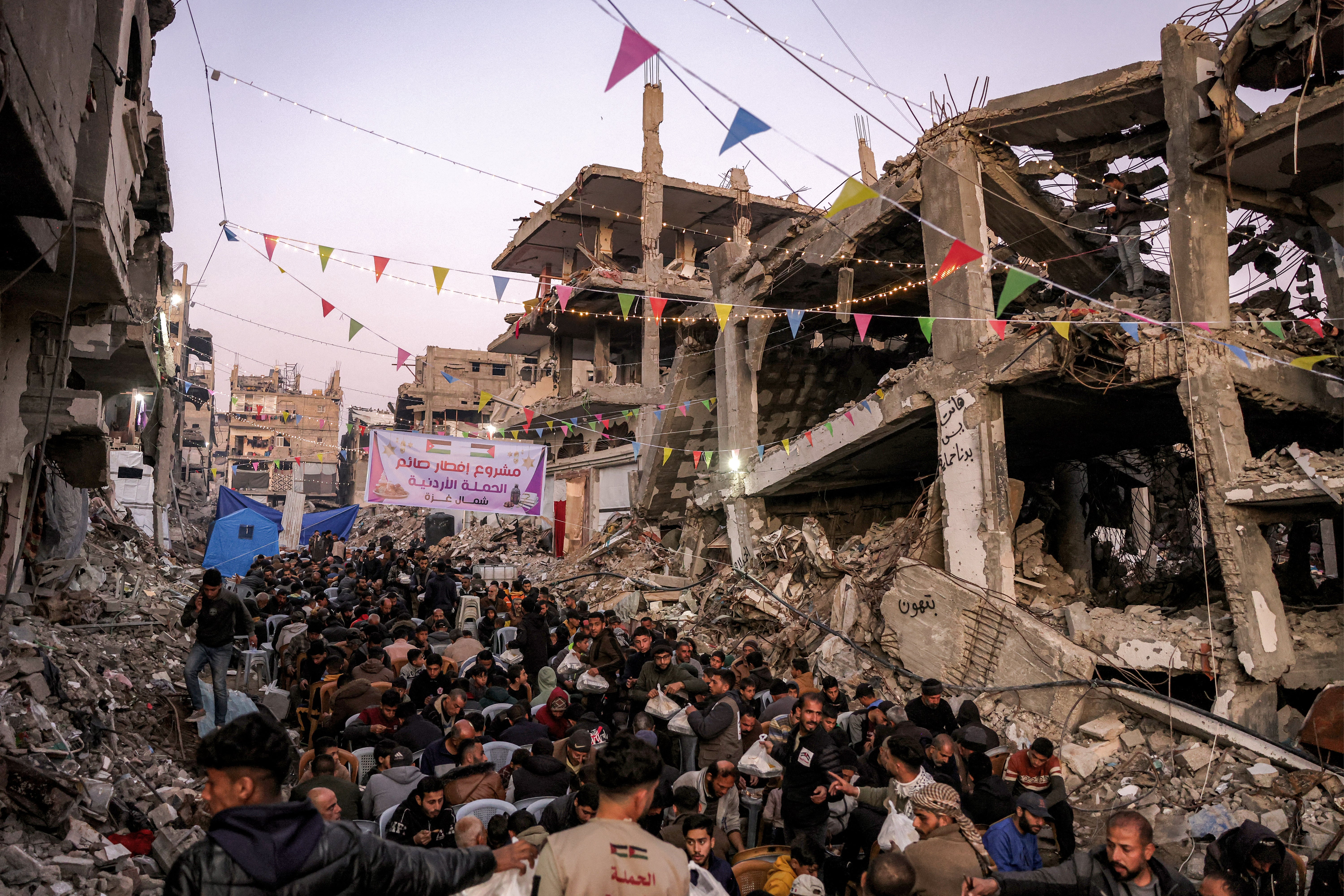 People gather for the iftar, or fast-breaking meal, on the first day of the Muslim holy fasting month of Ramadan