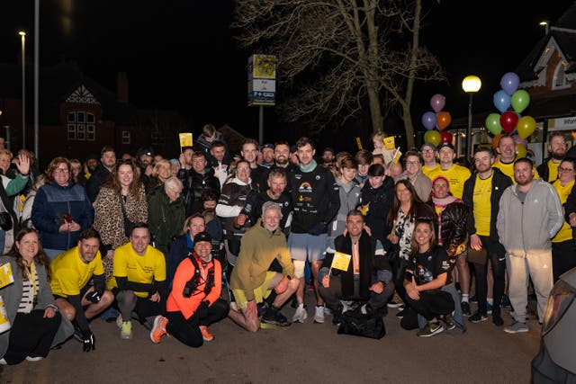 Alex Rigby (centre) with supporters at the end of his charity run to each station on the Merseyrail network (Merseyrail/PA)