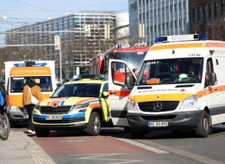 Ambulance vehicles are parked near the scene