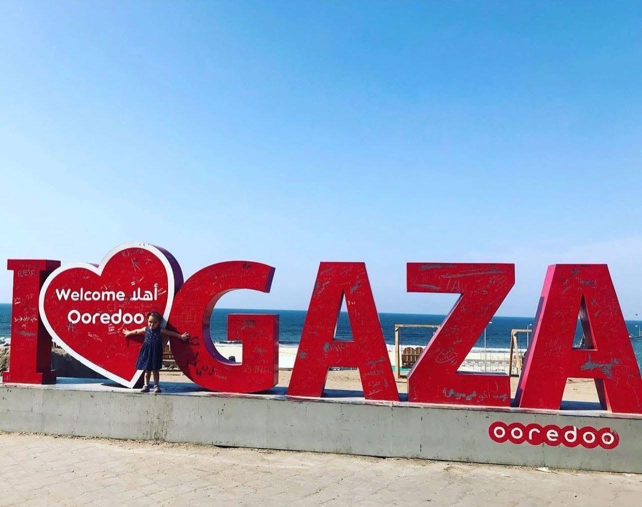 Laila ElHaddad’s daughter on the promenade in Gaza. The sign is now destroyed