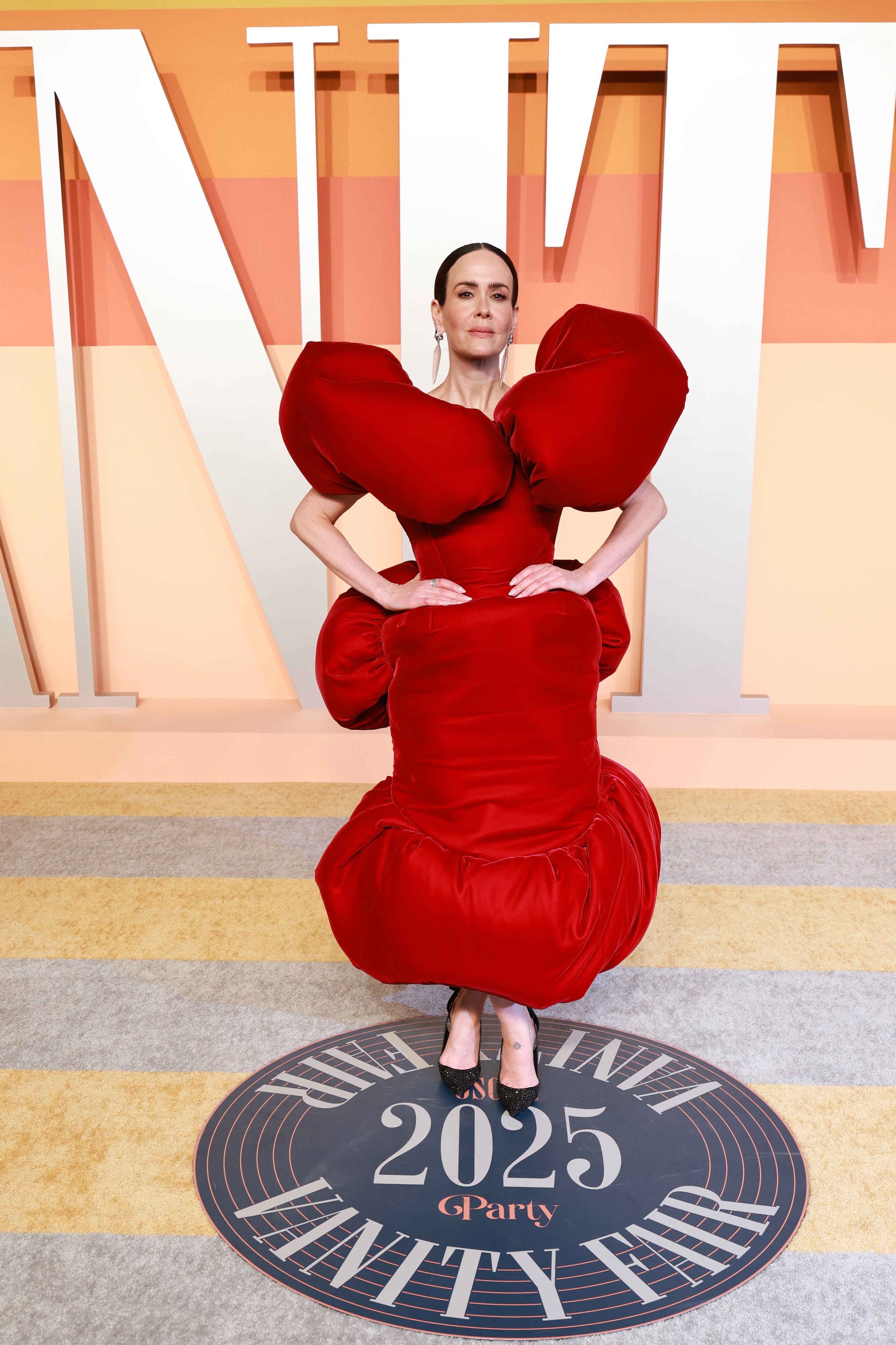 Sarah Paulson stepped out in a hot red ballooned ensemble with puffed sleeves and black pointed-toe pumps