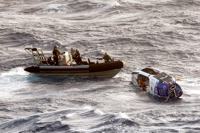 <p>Australian Navy ship HMAS Choules rescuing Lithuanian long-distance rower Aurimas Mockus from storm-tossed seas off Australia</p>