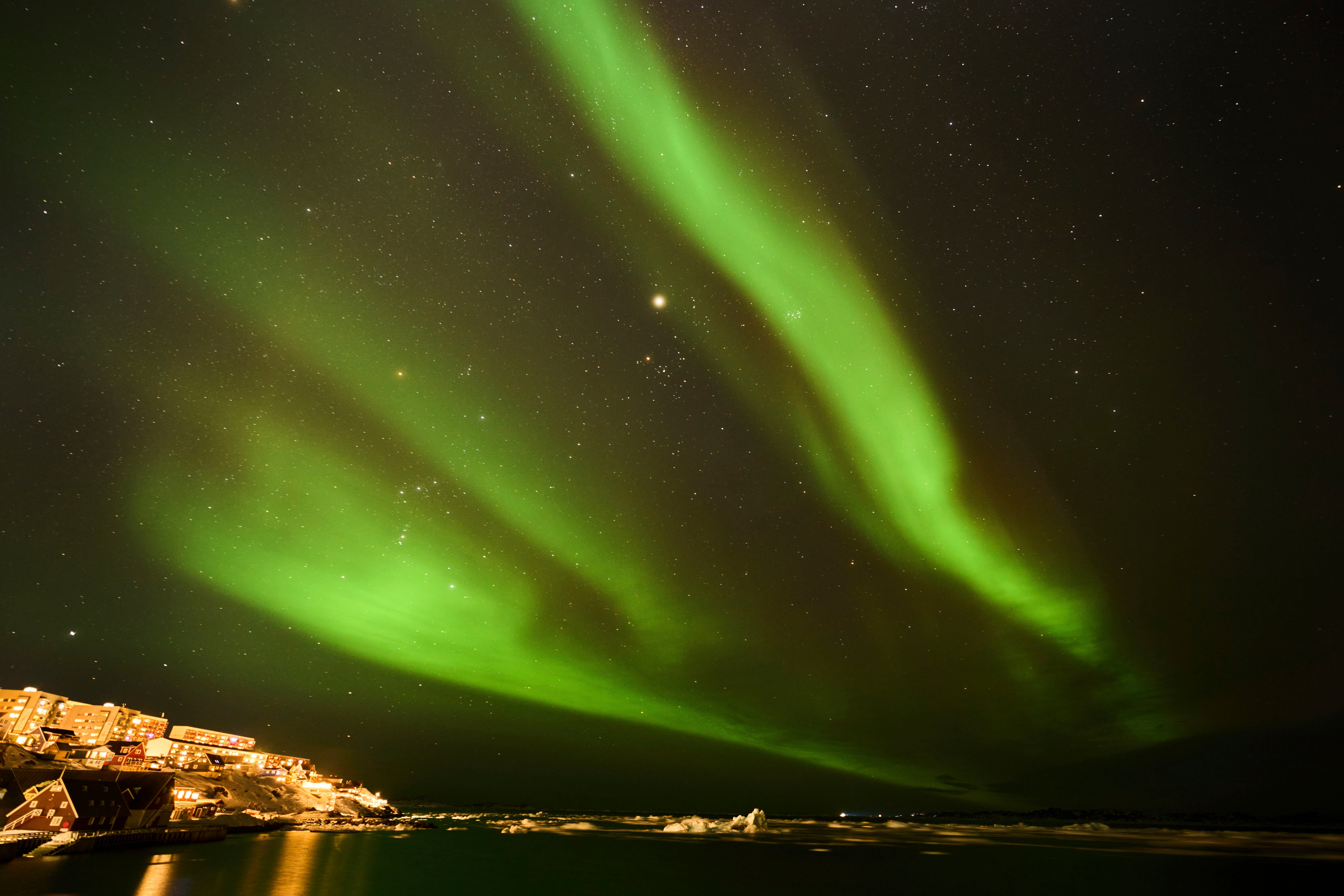 The Northern Lights appear over homes in Nuuk, Greenland, in February