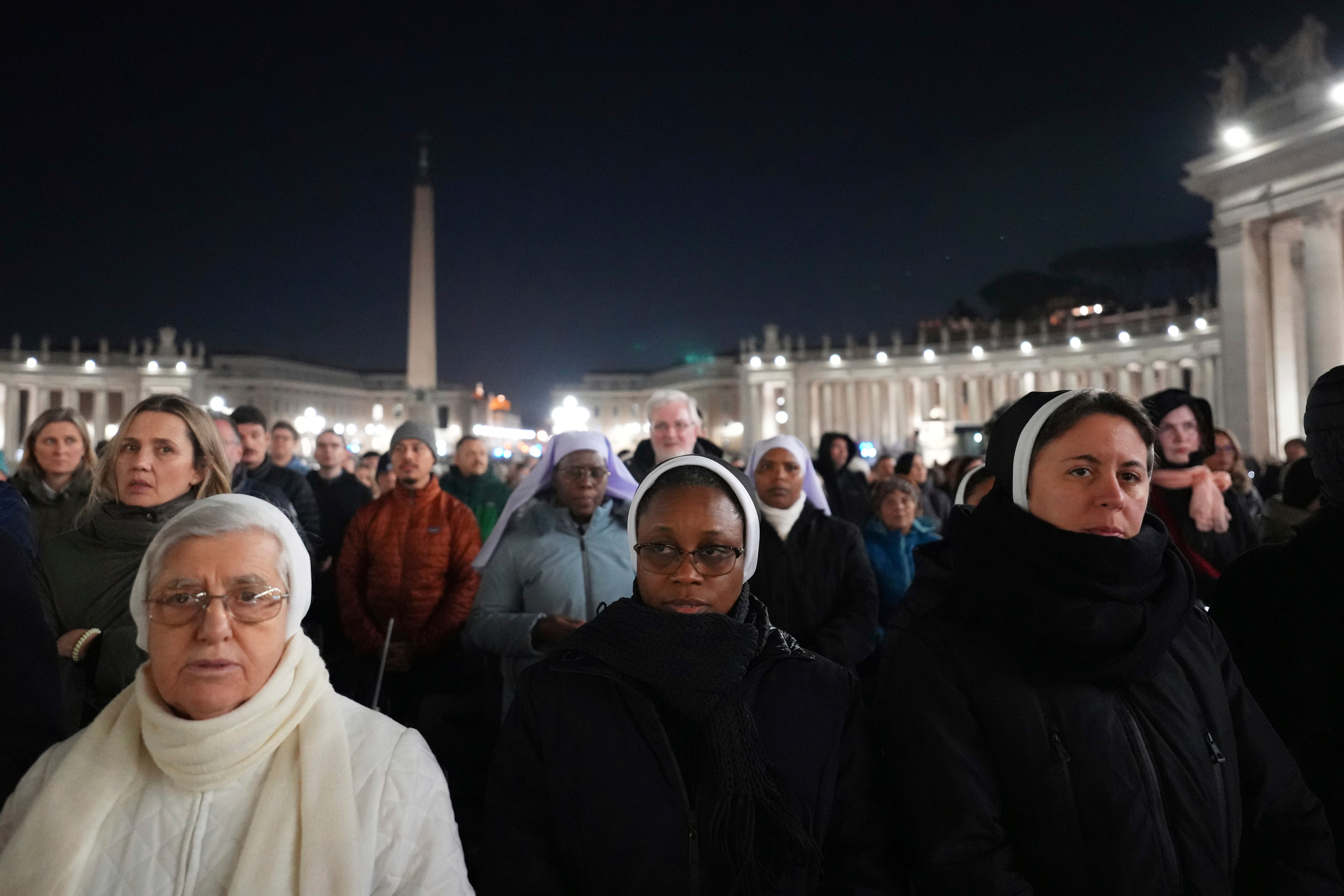 People attend the recitation of the Holy Rosary for Pope Francis' health in St Peter's Square