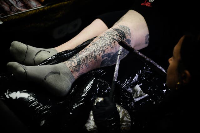 <p>File. A person gets their leg tattooed during the Brighton Tattoo Convention</p>