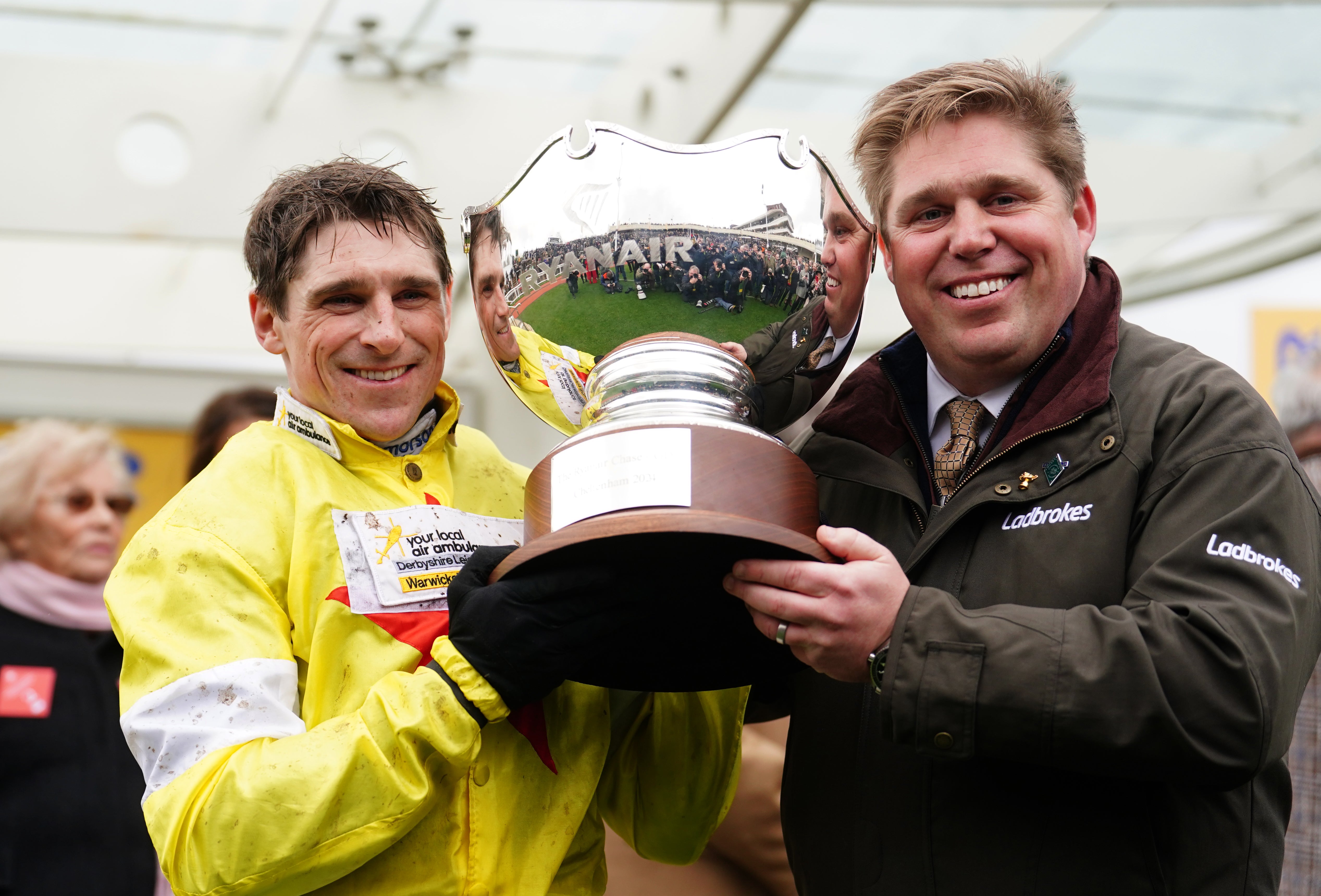 Jockey Harry Skelton (left) and trainer Dan Skelton (right) celebrate Protektorat's win in the Ryanair Steeplechase