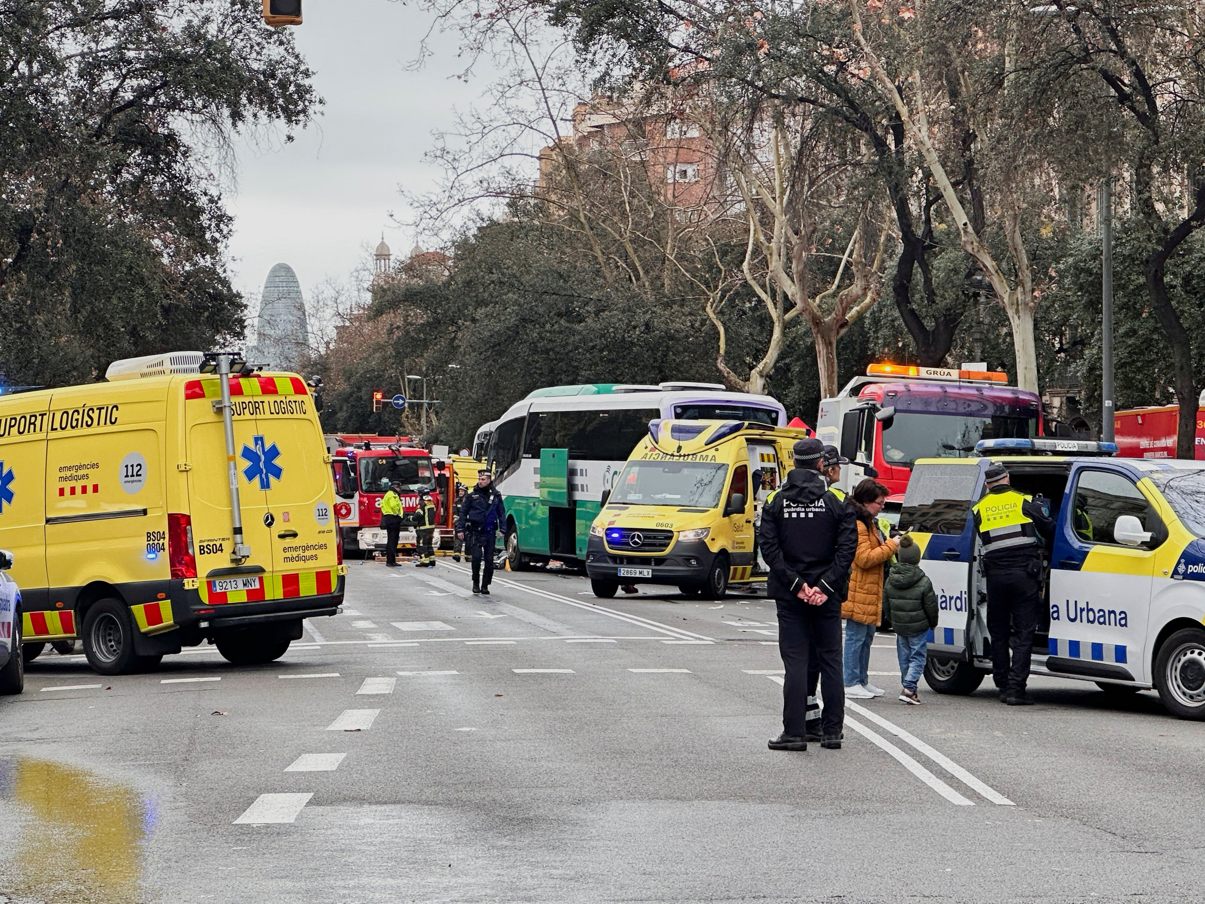 Emergency services work at the site of a collision between two tourist buses