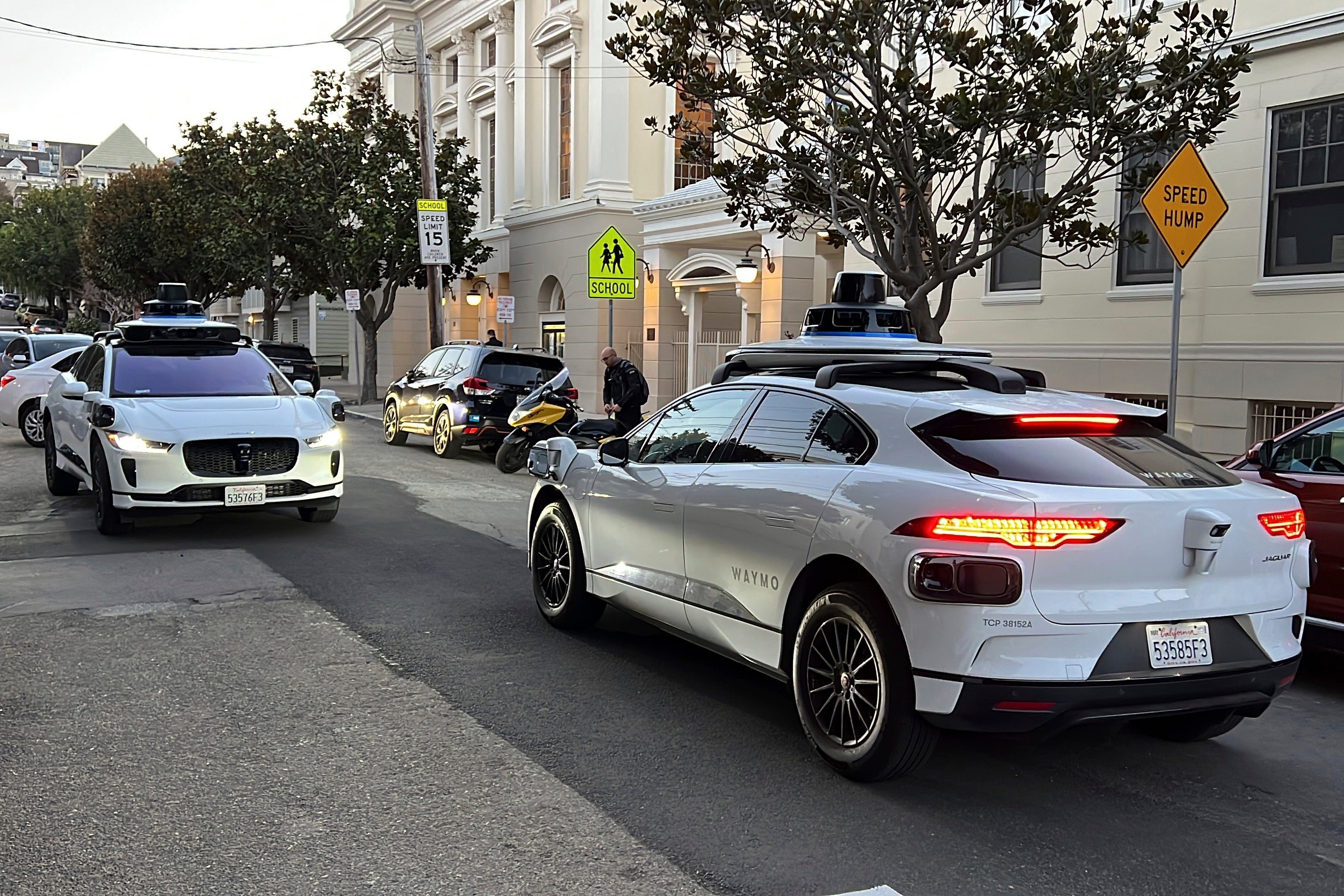 Two Waymo robotaxis on a San Francisco street