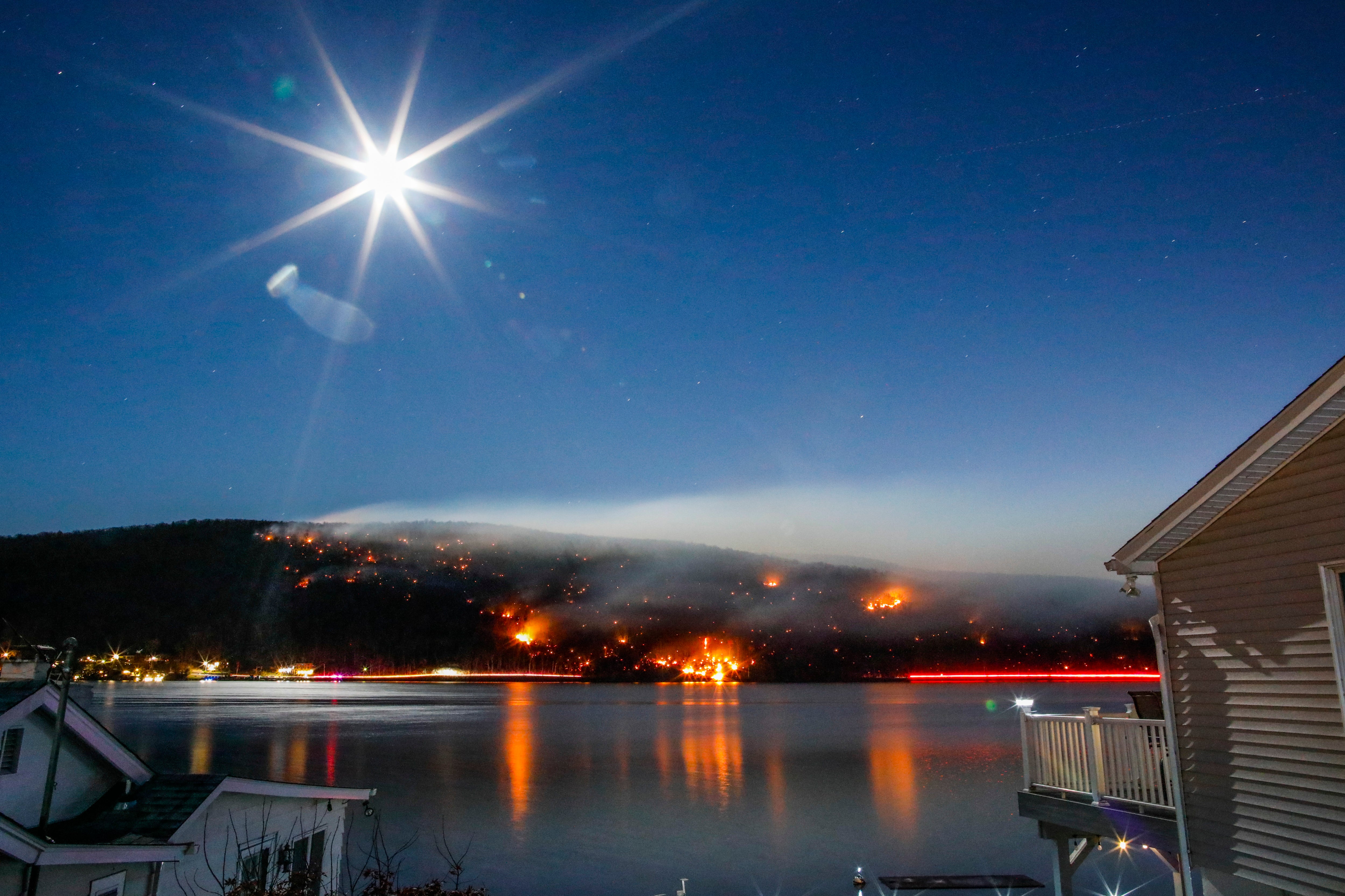 Smoke rises from New York’s Jennings Creek wildfire last fall, as the moon rises. Late-year fires in the Northeast occurred amid widespread and prolonged drought