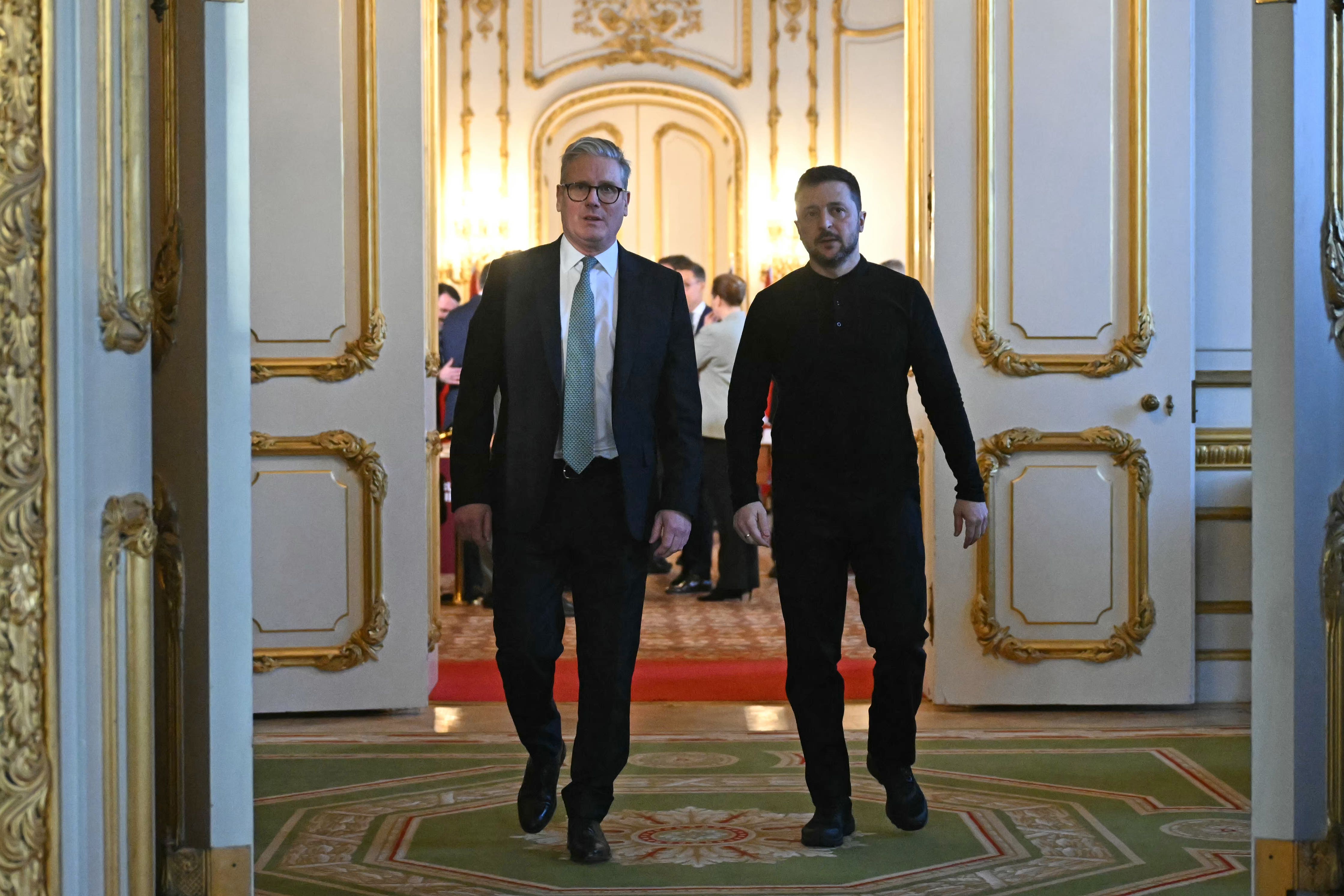 Ukraine’s President Volodymyr Zelensky and Prime Minister Sir Keir Starmer head to a private room to hold a meeting during a Leaders’ Summit on the situation in Ukraine at Lancaster House, London (Justin Tallis/PA)
