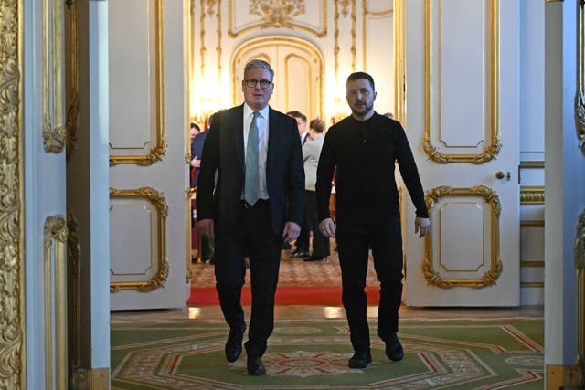 Ukraine’s President Volodymyr Zelensky and Prime Minister Sir Keir Starmer head to a private room to hold a meeting during a Leaders’ Summit on the situation in Ukraine at Lancaster House, London (Justin Tallis/PA)