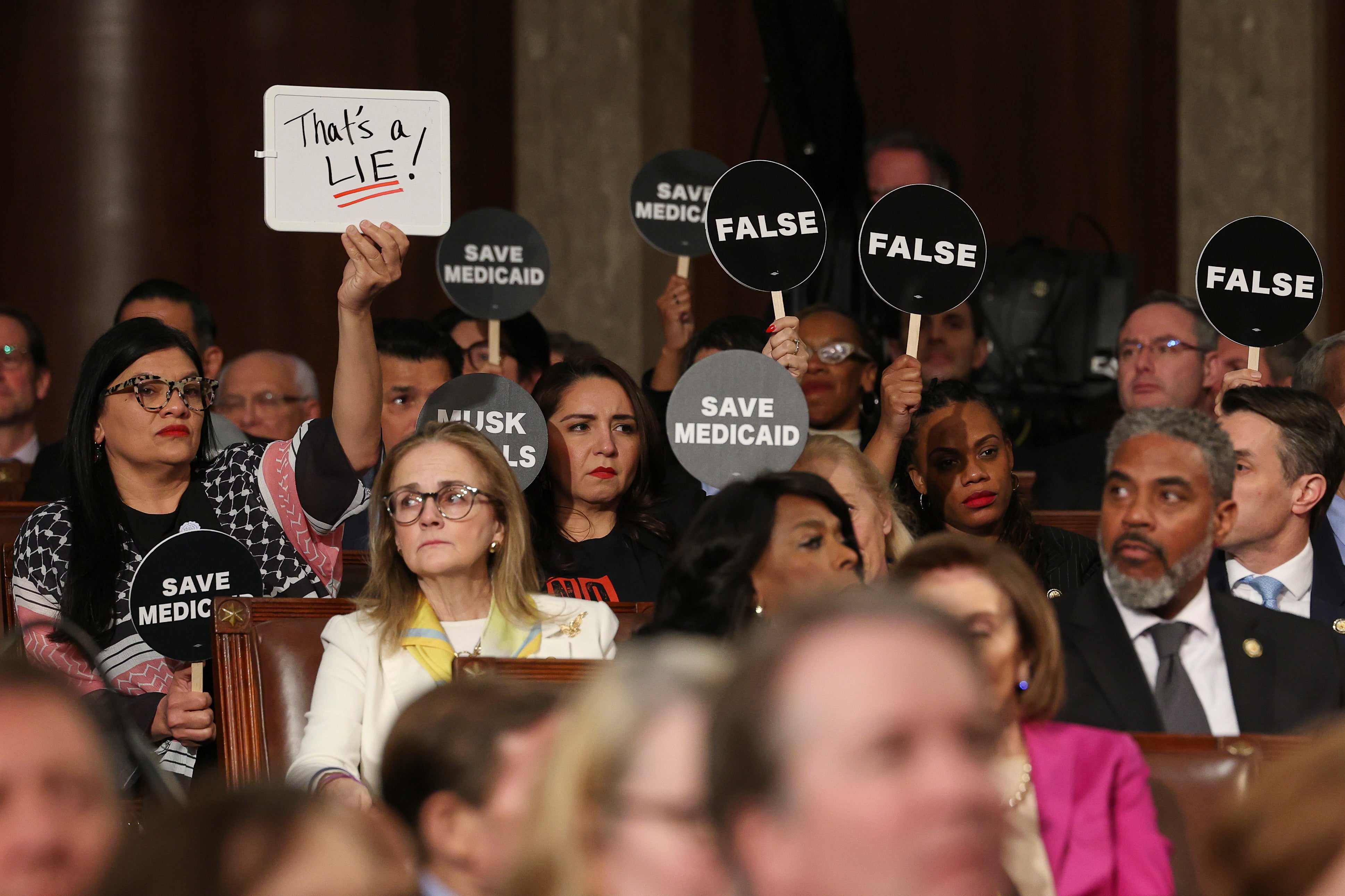 Democrats pushed back against Trump during his long-winded joint address on Tuesday by holding up signs