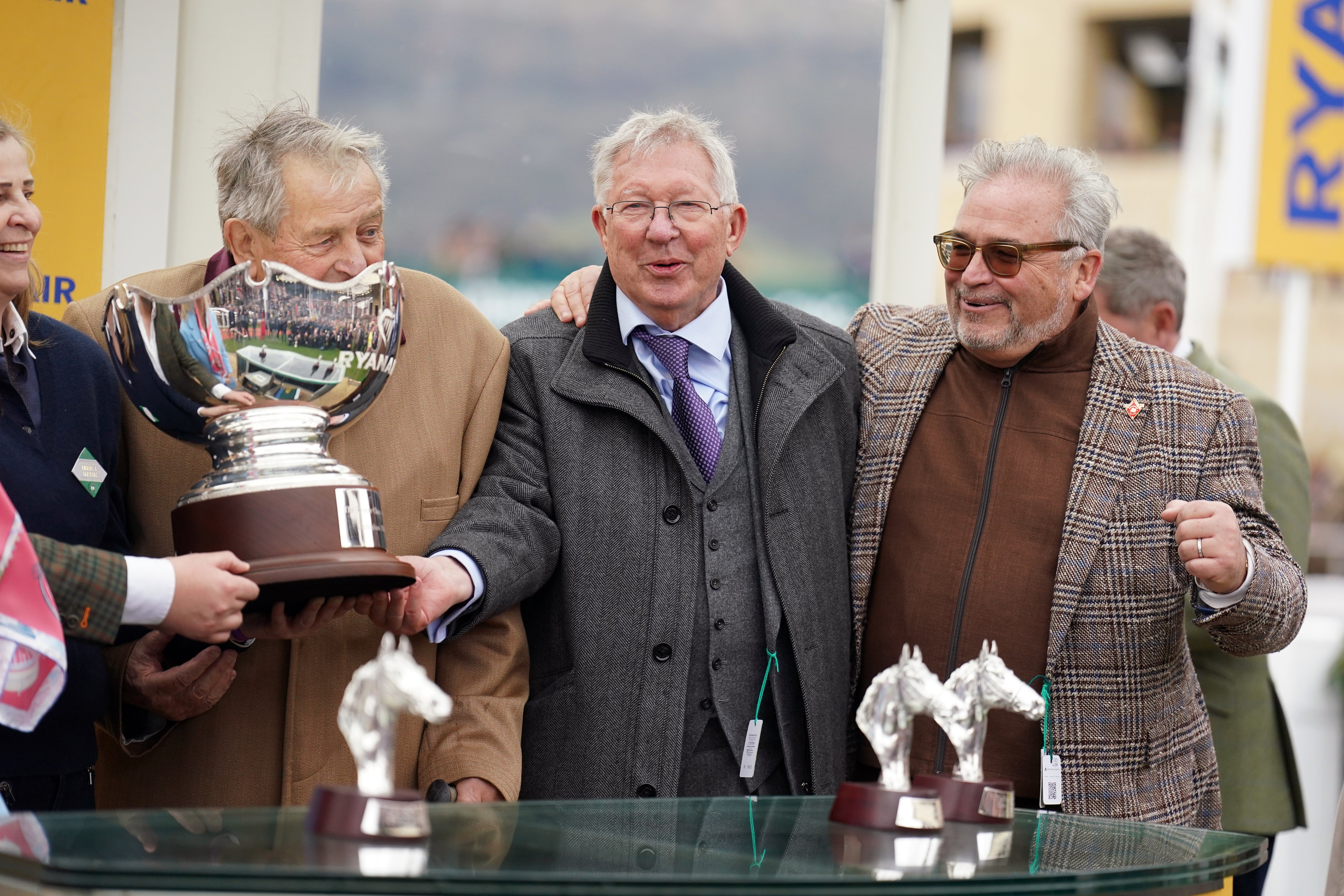 Ferguson (middle) celebrates Protektorat's win at Cheltenham with joint owners John Hales (left) and Ged Mason (right)